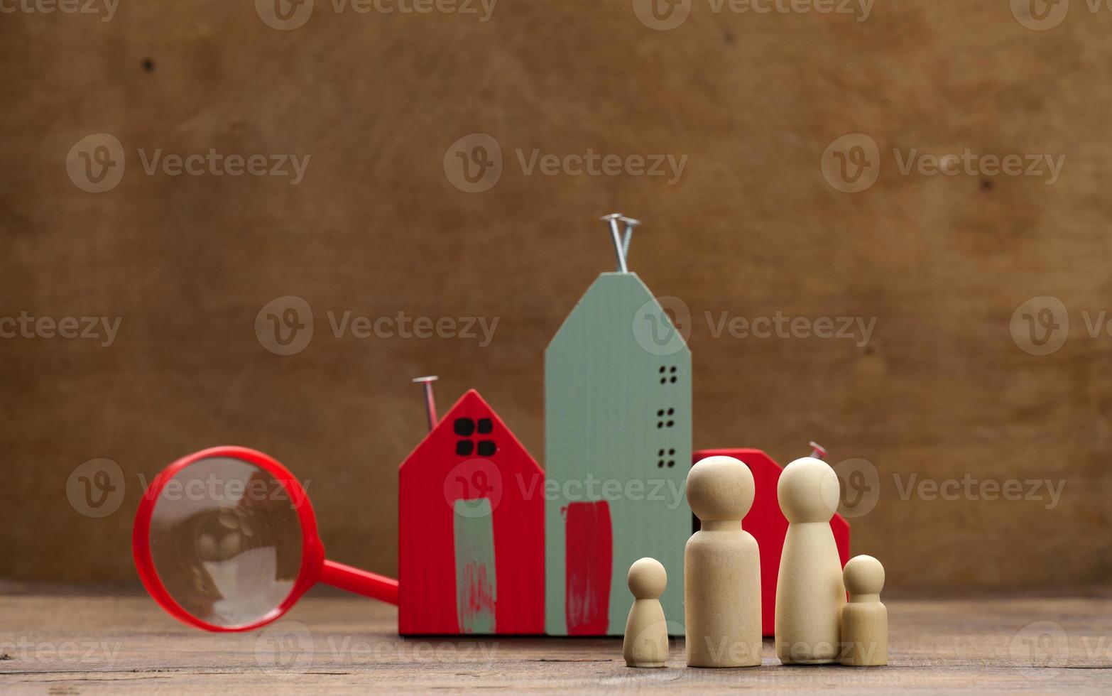 wooden family figurines, model house on a brown background. Real estate purchase, rental concept. Moving to new apartments photo