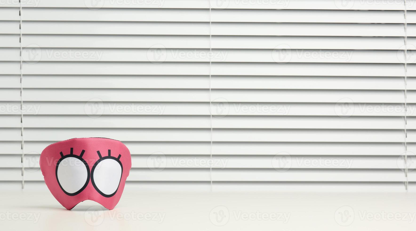 pink textile mask on a white background photo