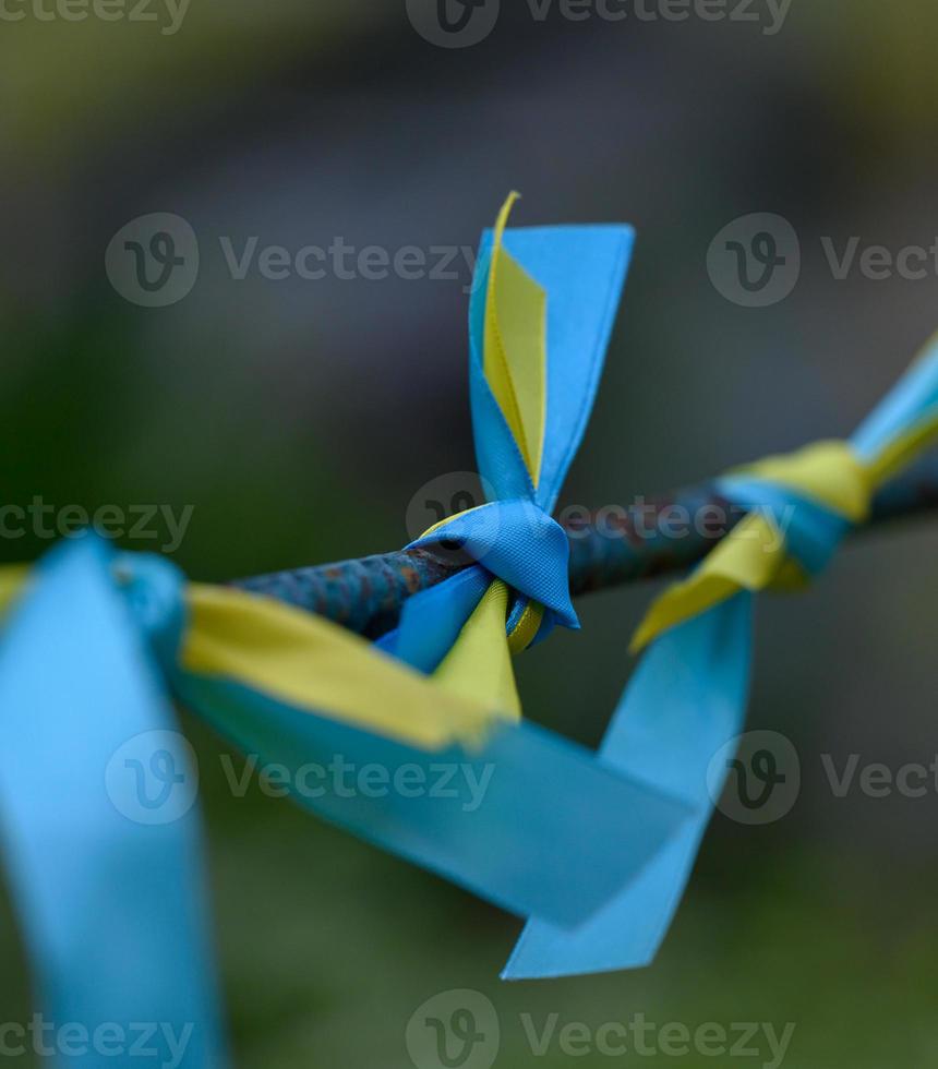 blue and yellow silk ribbon tied on a metal tube. Ukrainian flag symbol, struggle for independence photo