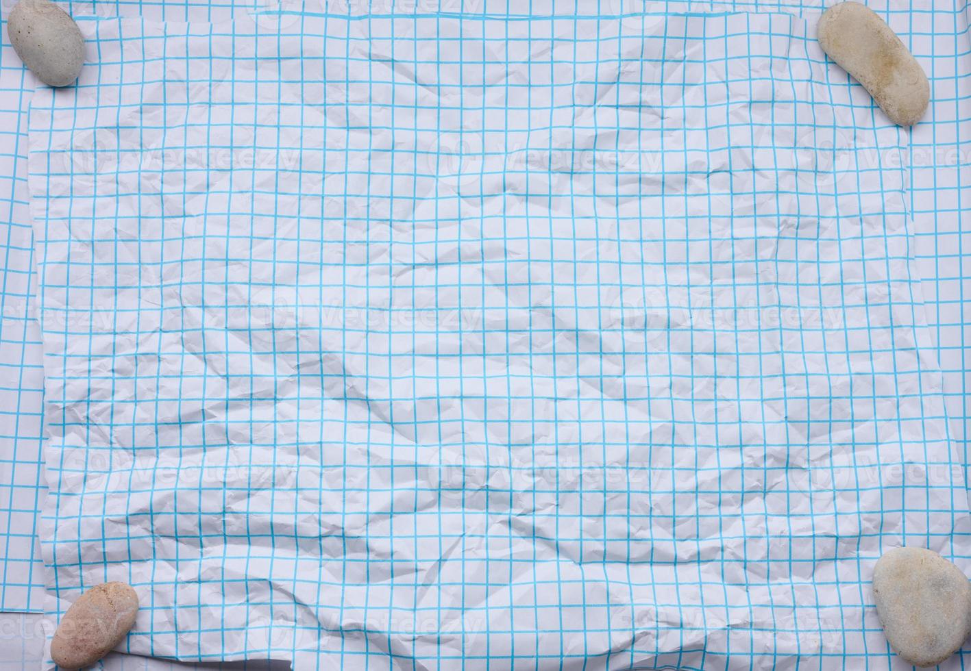 crumpled white paper texture in a cage, blue lines, school notebook photo