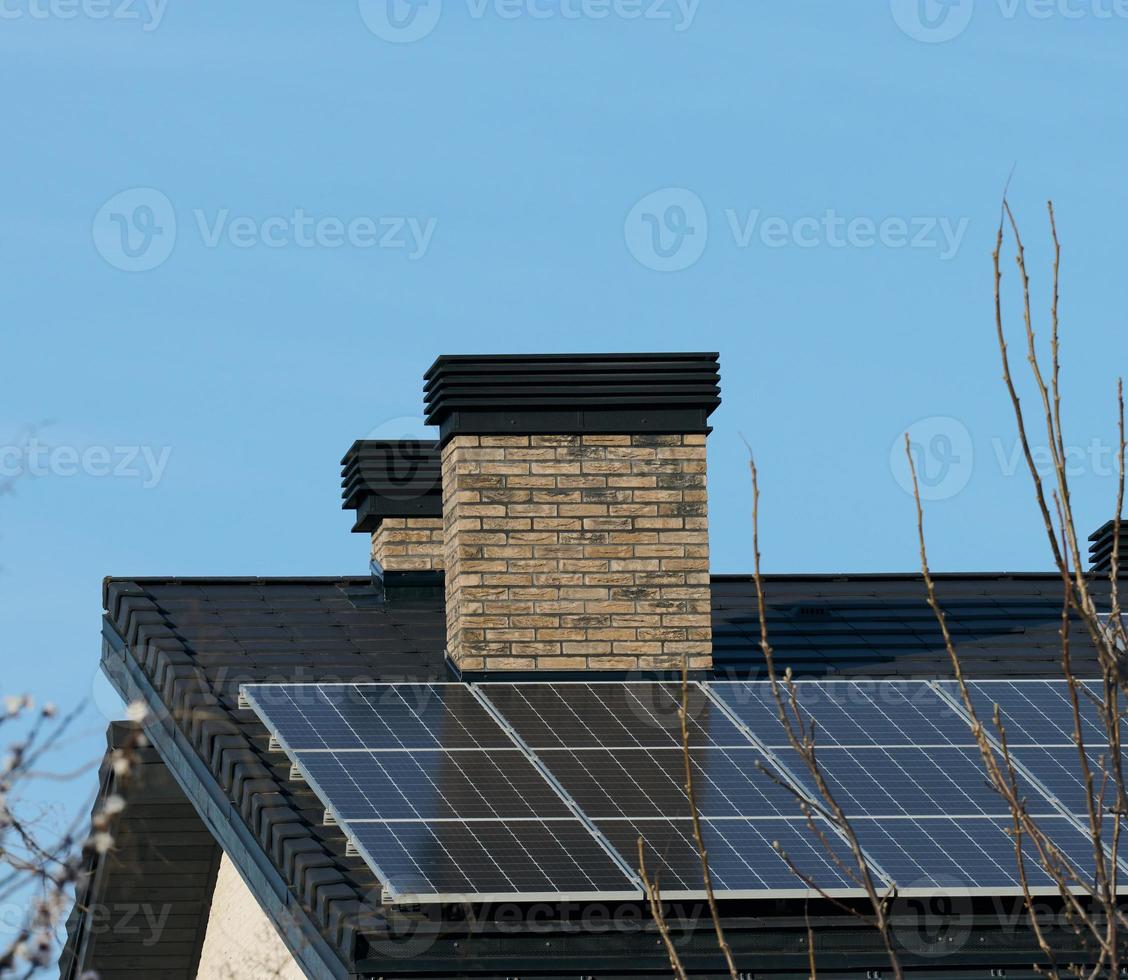 roof of a residential building with solar panels. Green energy and energy independence concept photo