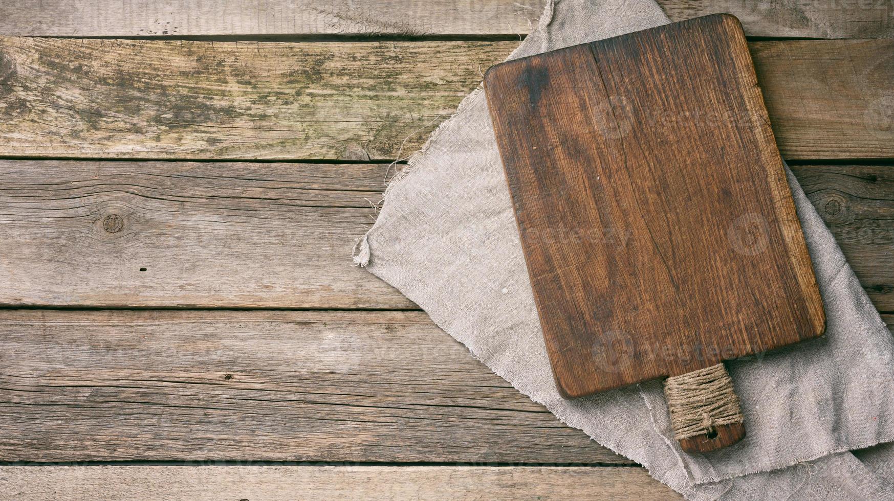 empty rectangular wooden cutting kitchen board on table, top view photo