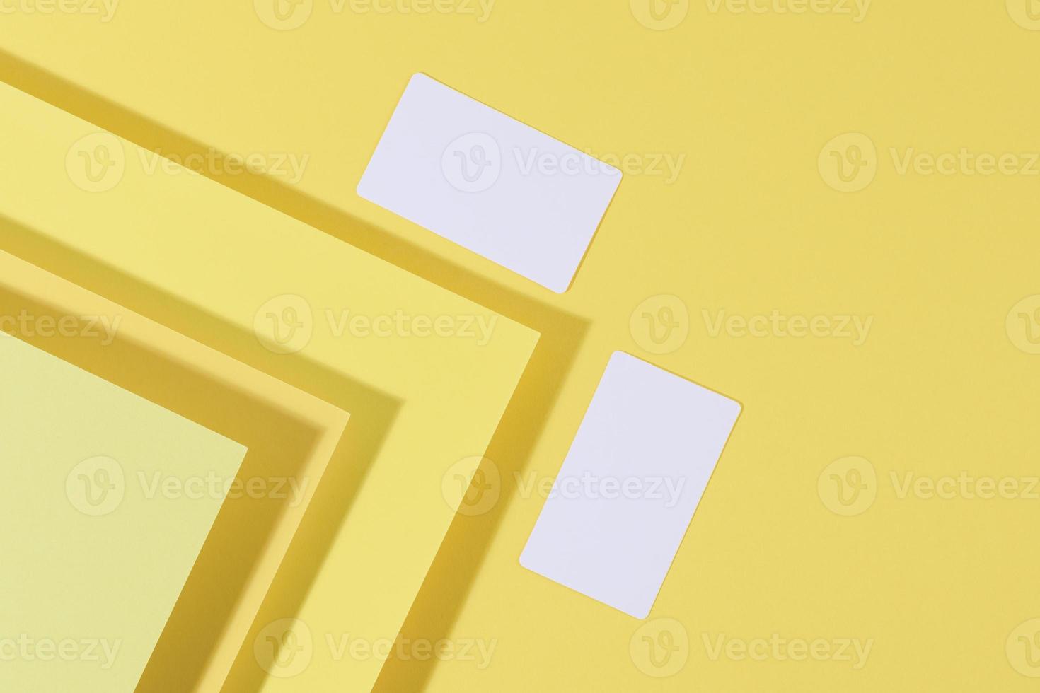 blank white rectangular business card on creative yellow background from sheets of paper with shadow photo