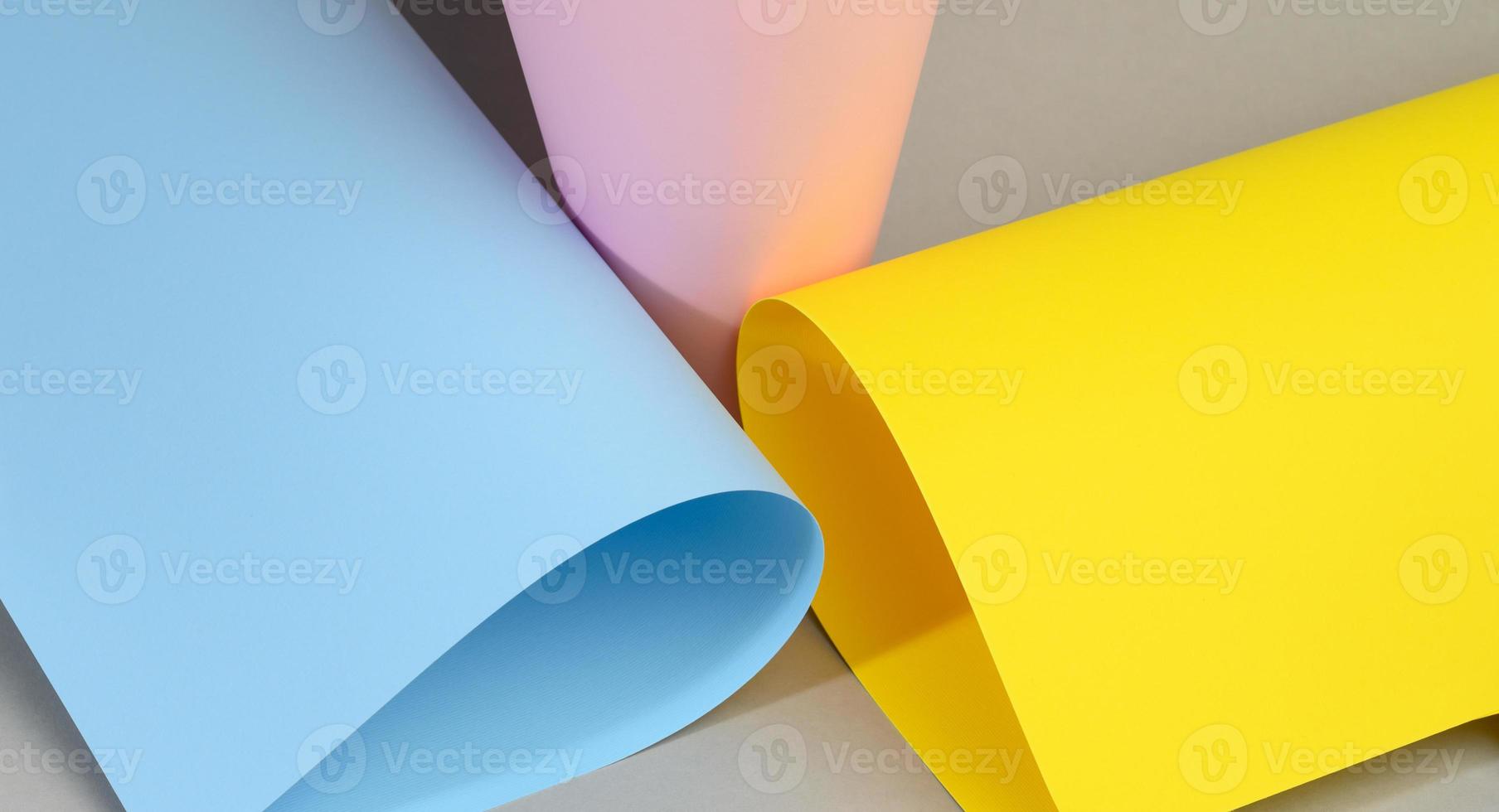 abstract background of curled sheets of multicolored paper with a shadow photo
