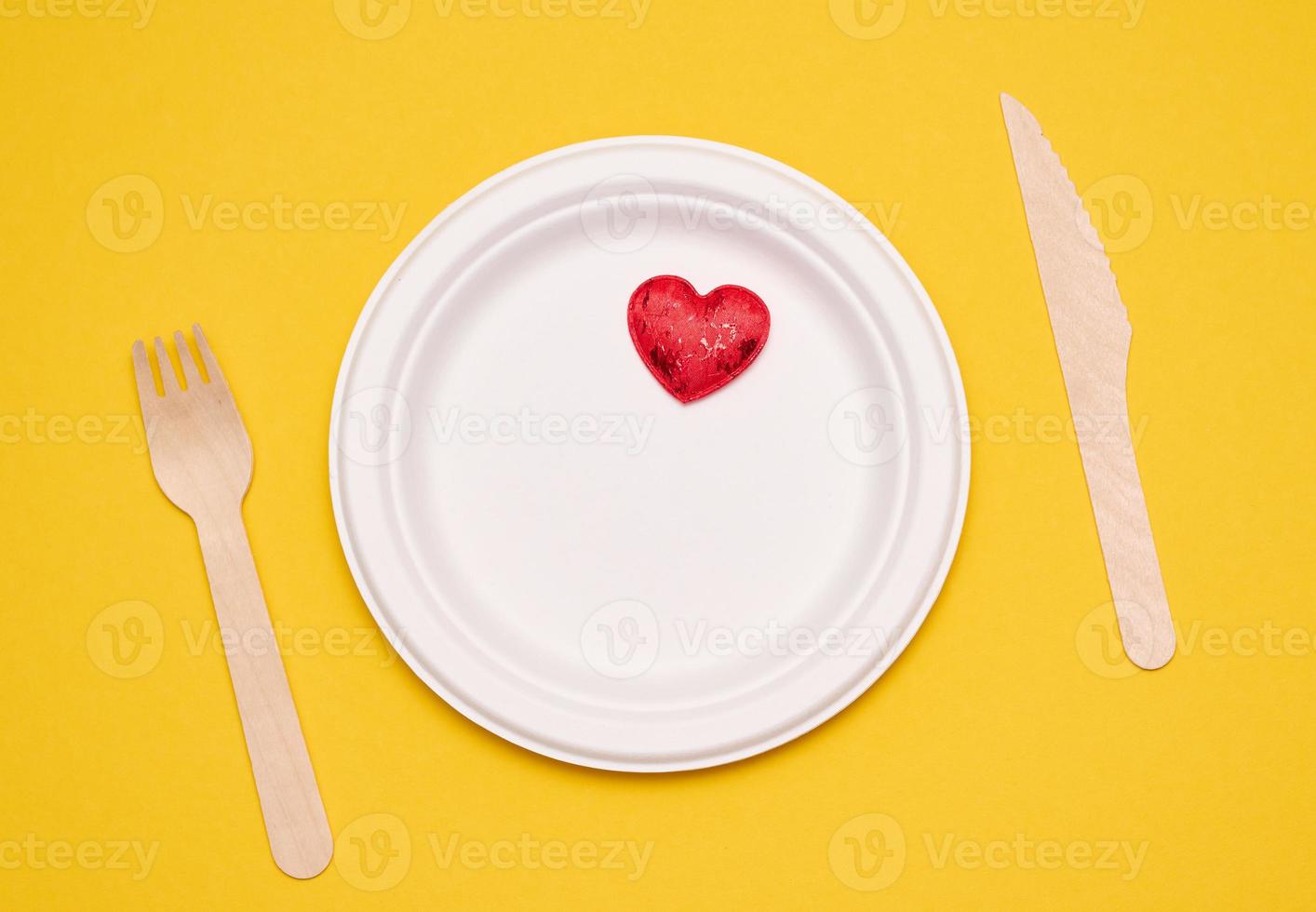 white plates on a yellow background. Recyclable garbage, rejection of plastic, top view photo