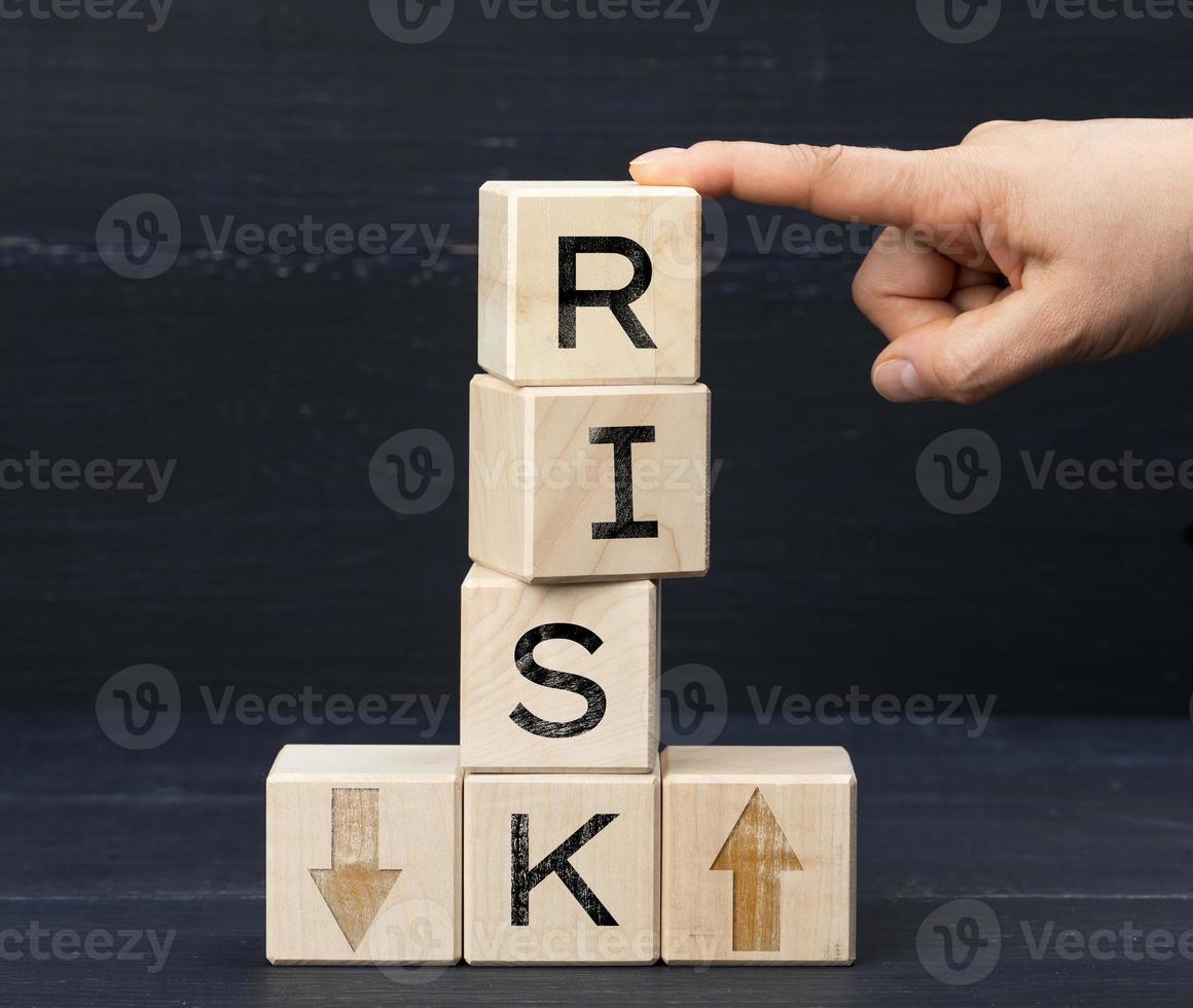 wooden cubes with the inscription risk on a blue background. Risk reduction concept, reinsurance photo