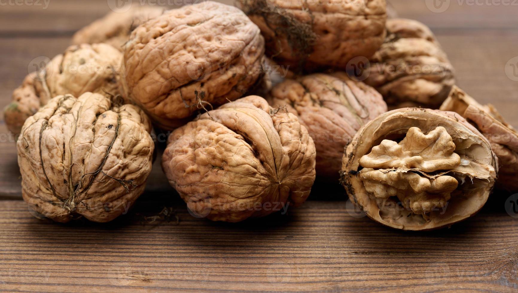 walnut on brown wooden table, close up photo