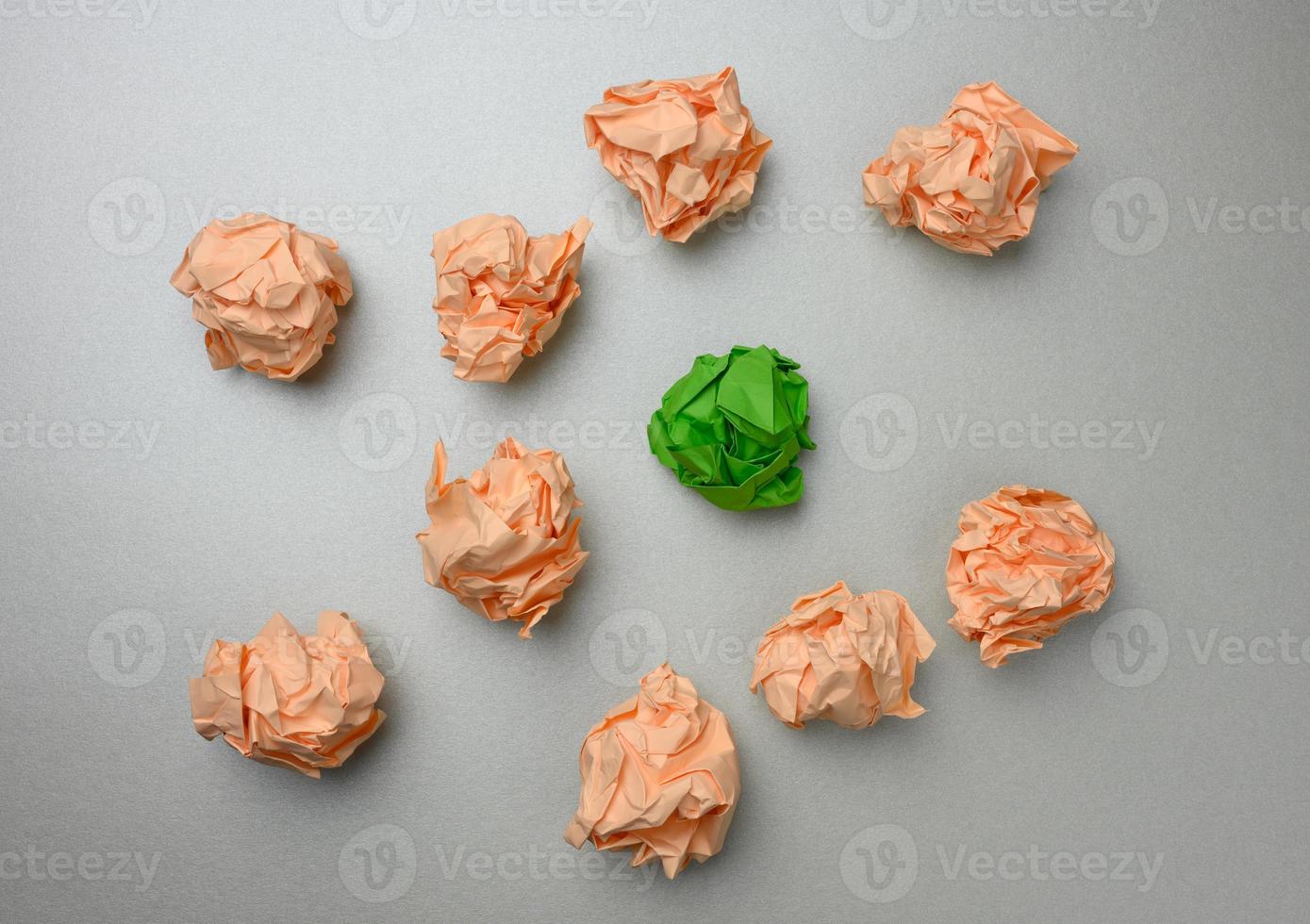 crumpled balls of paper on a gray background, top view. The concept of finding innovative ideas, the right solutions photo