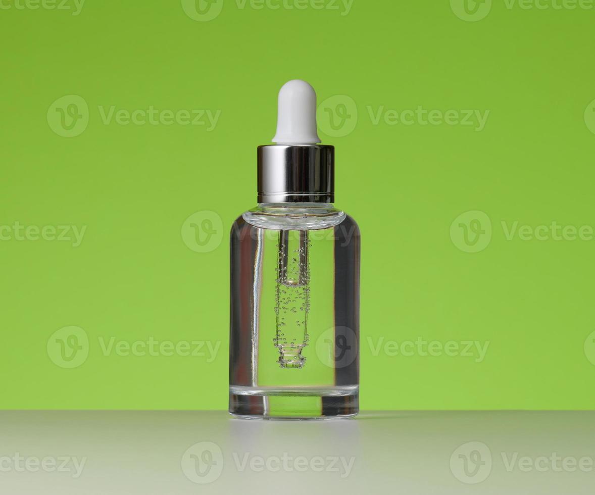 white glass bottle with pipette for cosmetics, oils and serum. Advertising and product promotion photo