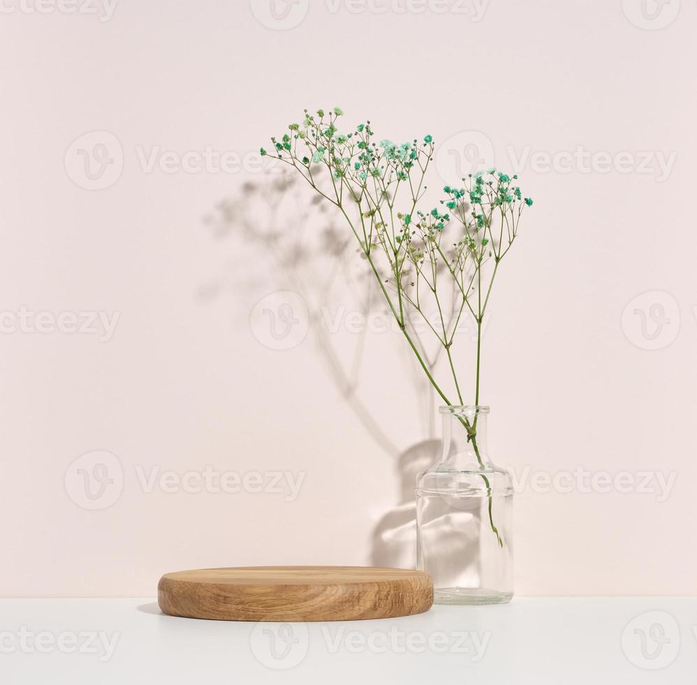 stage for displaying products, cosmetics with a round wooden podium photo