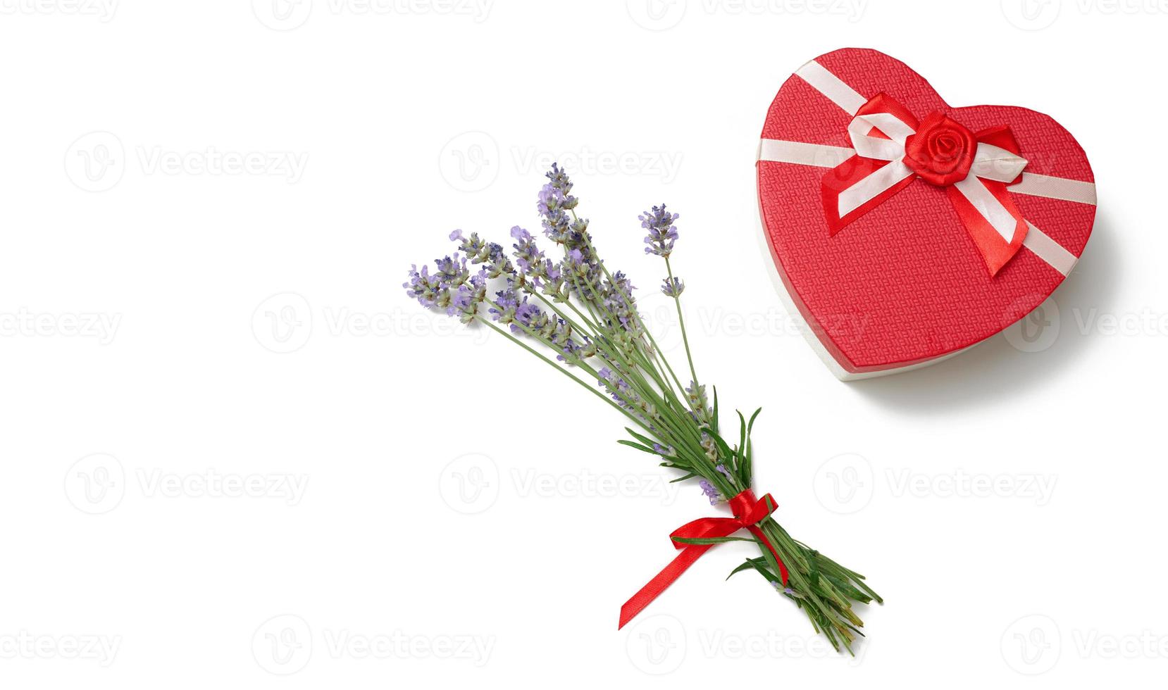 Lavender bouquet and heart shaped cardboard red gift box on white background, top view photo