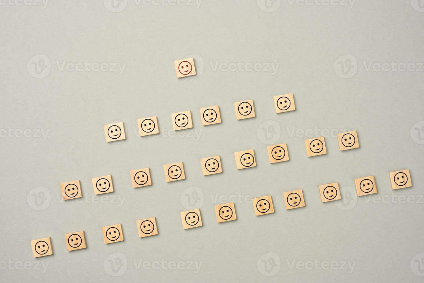 wooden blocks with figures on a gray  background, hierarchical organizational structure of management photo