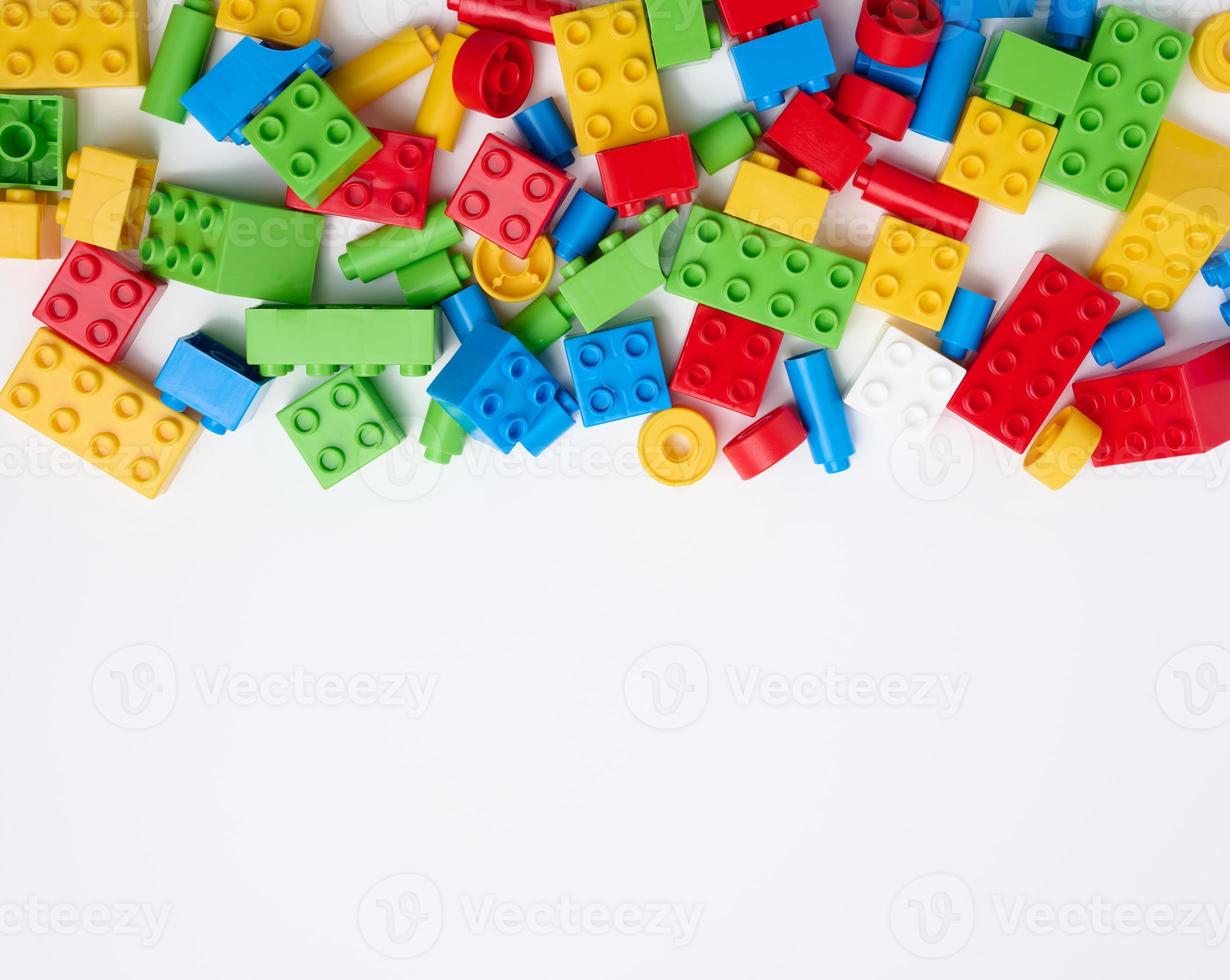 Scattered parts of a plastic children's designer, top view. White background photo