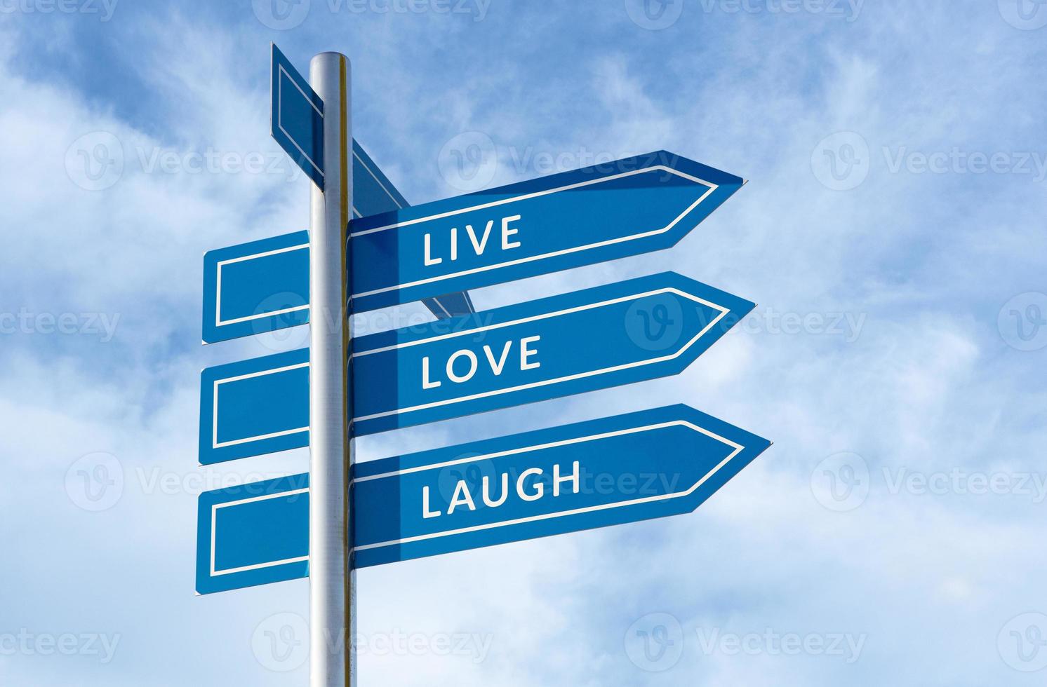 Live Love Laugh message on signpost isolated on blue sky background photo