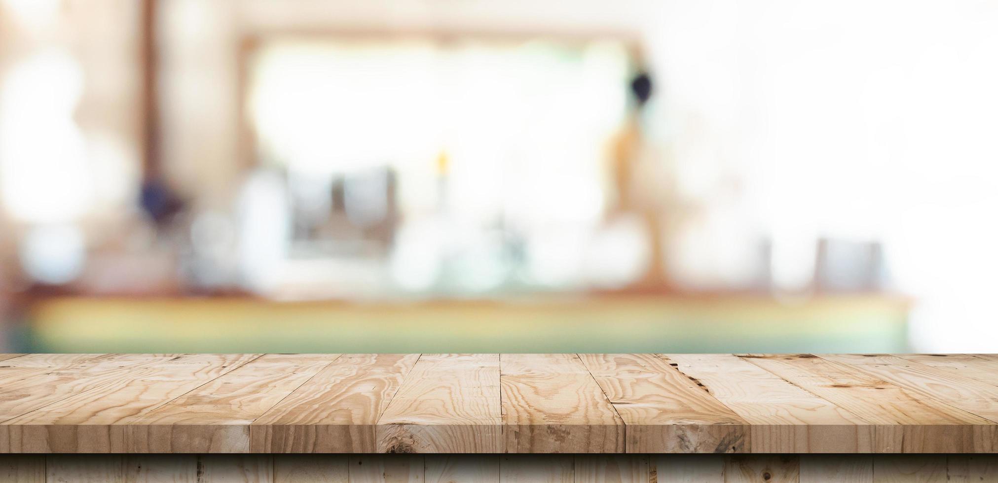 Wooden table top with blurred people in coffee shop and cafe background for display montage, copy space. photo