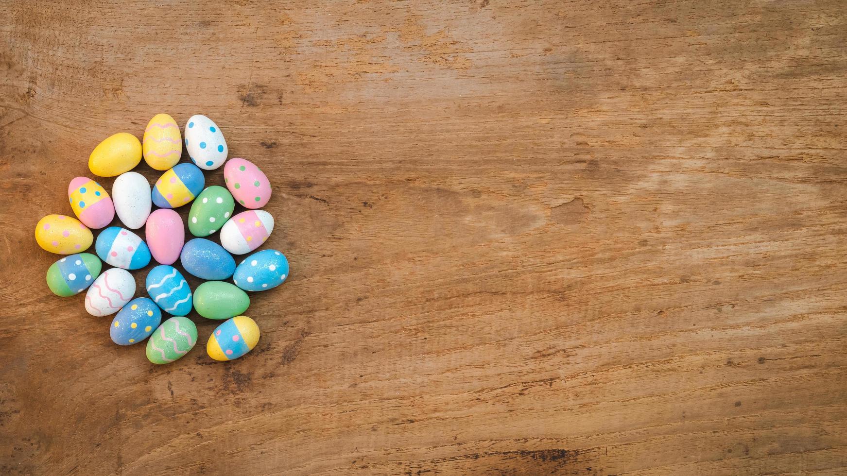 Colorful Easter Egg on a rustic old wood background. Above view with copy space. photo