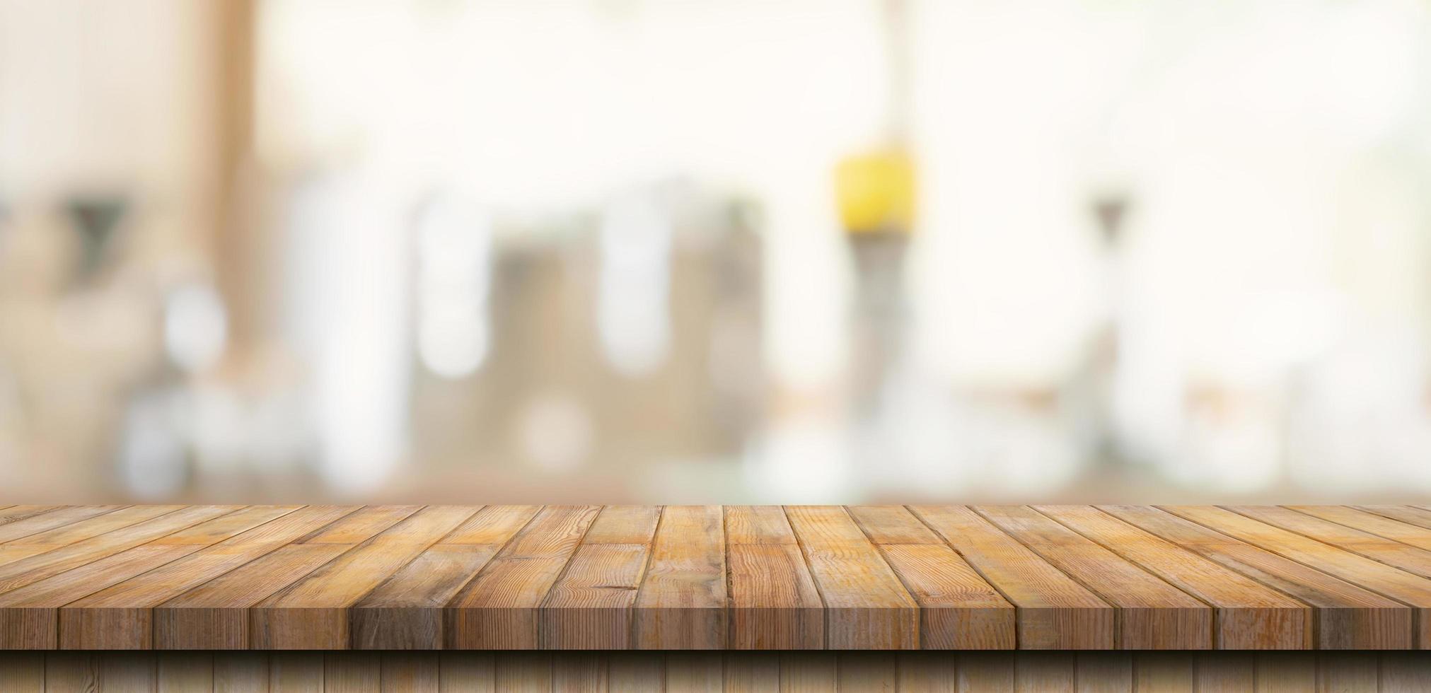 Wooden table top with blurred people in coffee shop and cafe background for display montage, copy space. photo