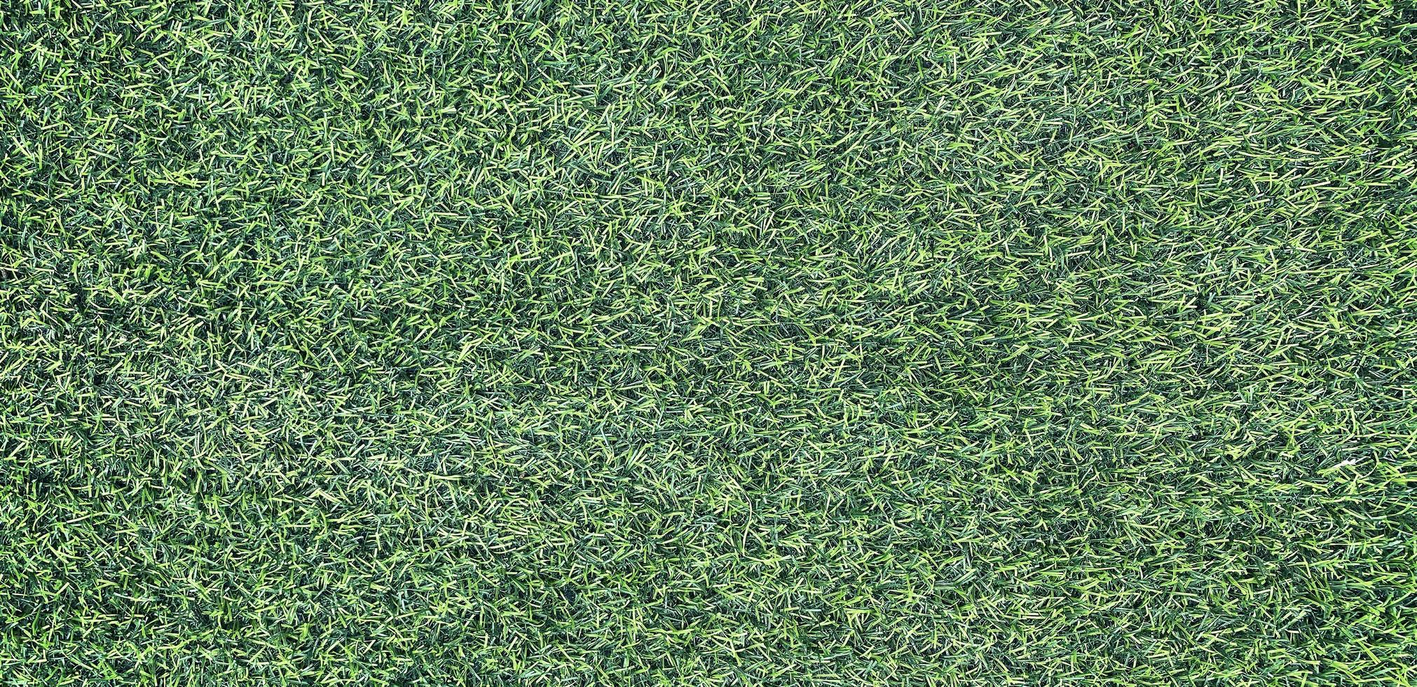 Panorama of New Green Artificial Turf Flooring texture and background photo