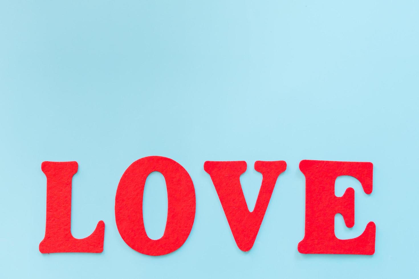 Love text on blue background with copy space photo
