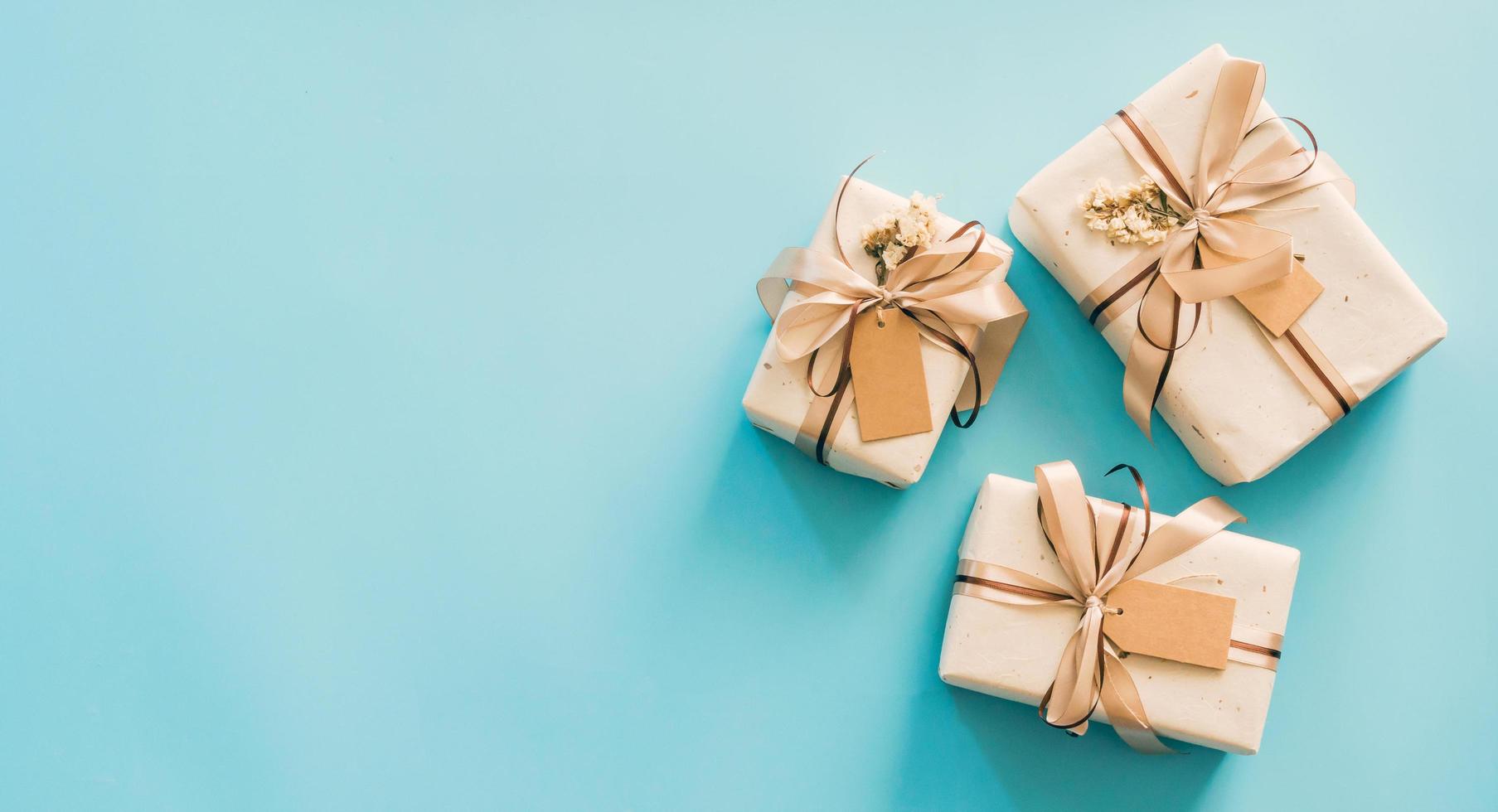 Craft paper gift boxs set on blue background with copy space for text. photo