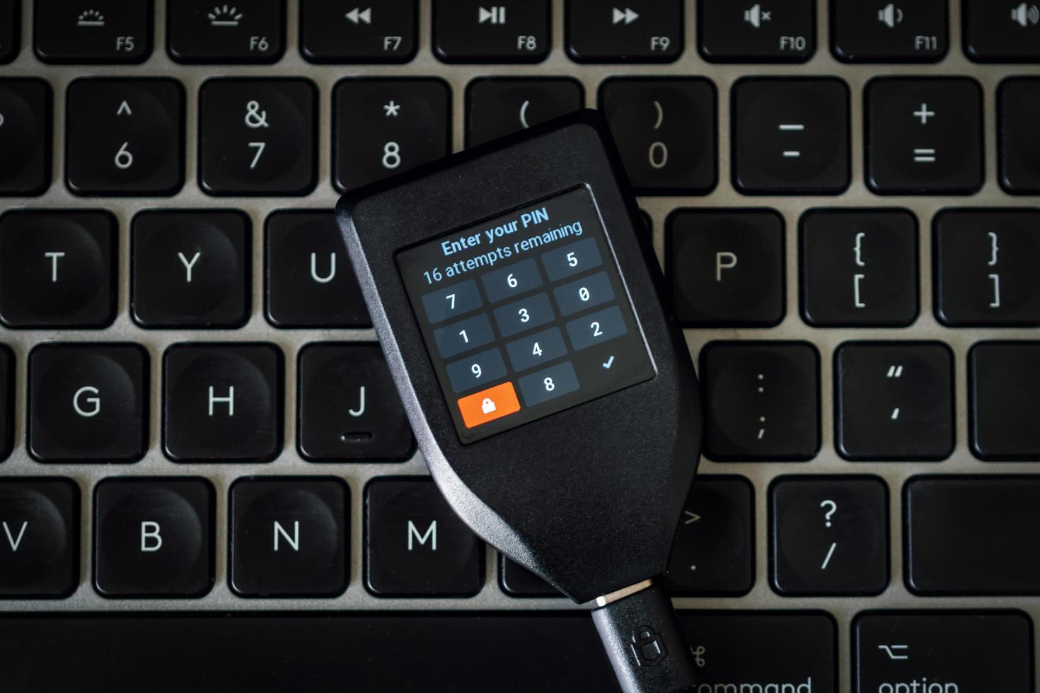Hardware Wallet for cryptocurrency on keyboard for pin code photo