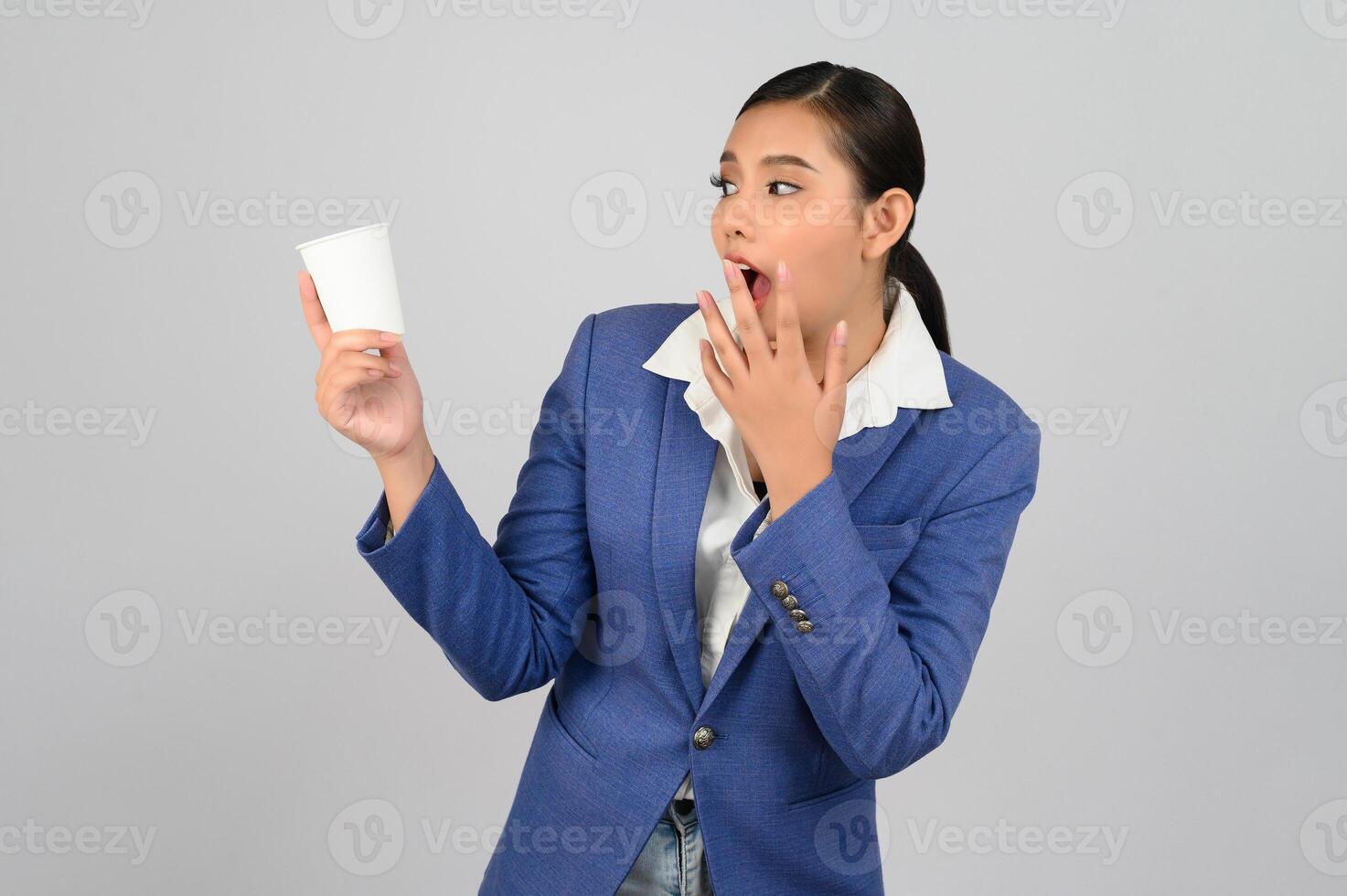 Young beautiful woman in formal clothing for officer show coffee cup photo