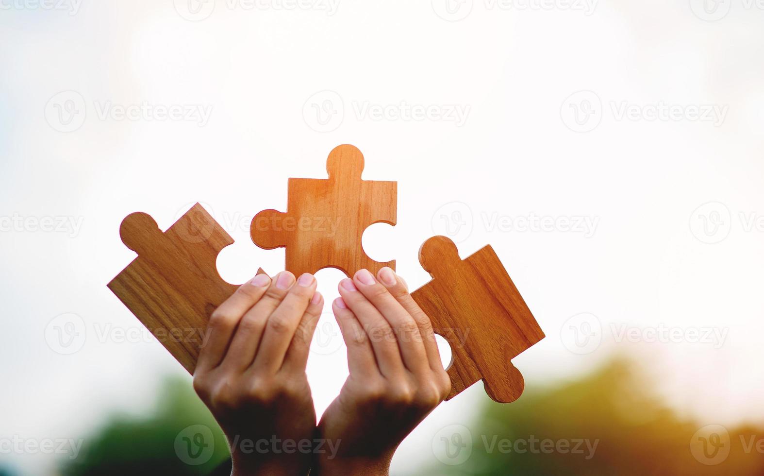 Team work concept, wooden puzzles put together. puzzle piece teamwork concept photo