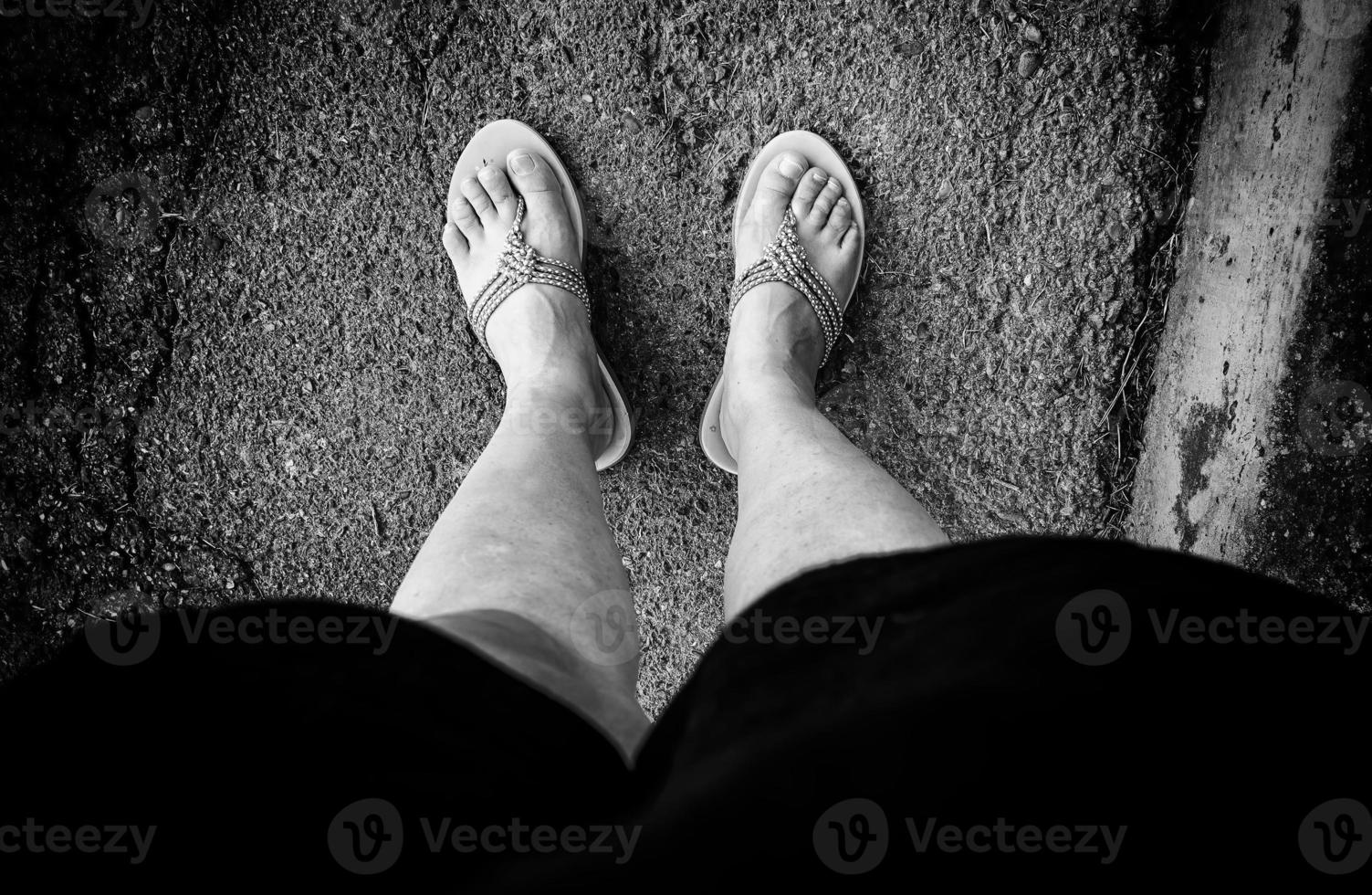 Woman's feet with flip flops photo