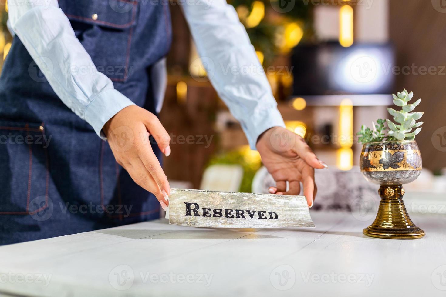 Elegant Restaurant Table Setting Service for Reception with Reserved Card. Restaurant reserved table sign photo