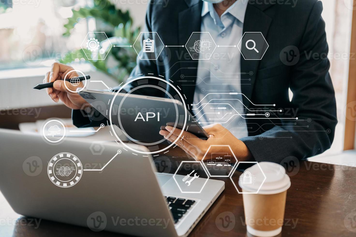 API Application Programming Interface, woman using laptop, tablet and smartphone with virtual screen API icon Software development tool, technology and networking concept. photo