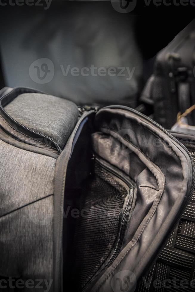 A detail of a modern dark grey half-opened backpack photo