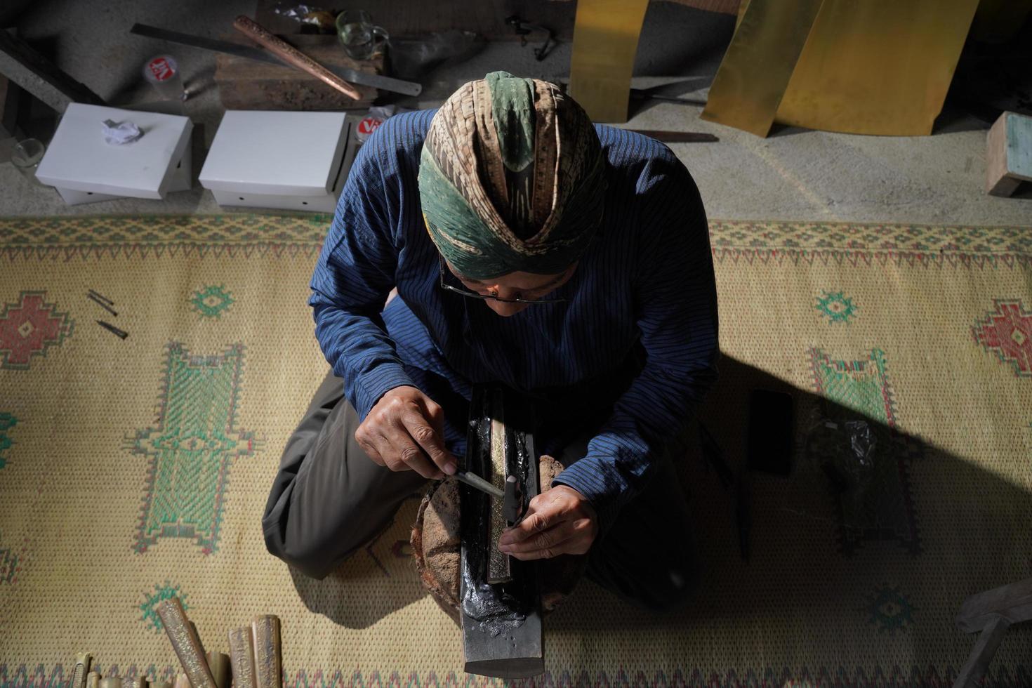 Keris craftsmen in the workshop, in the process of making keris. Bantul, Indonesia - 25 August 2022 photo