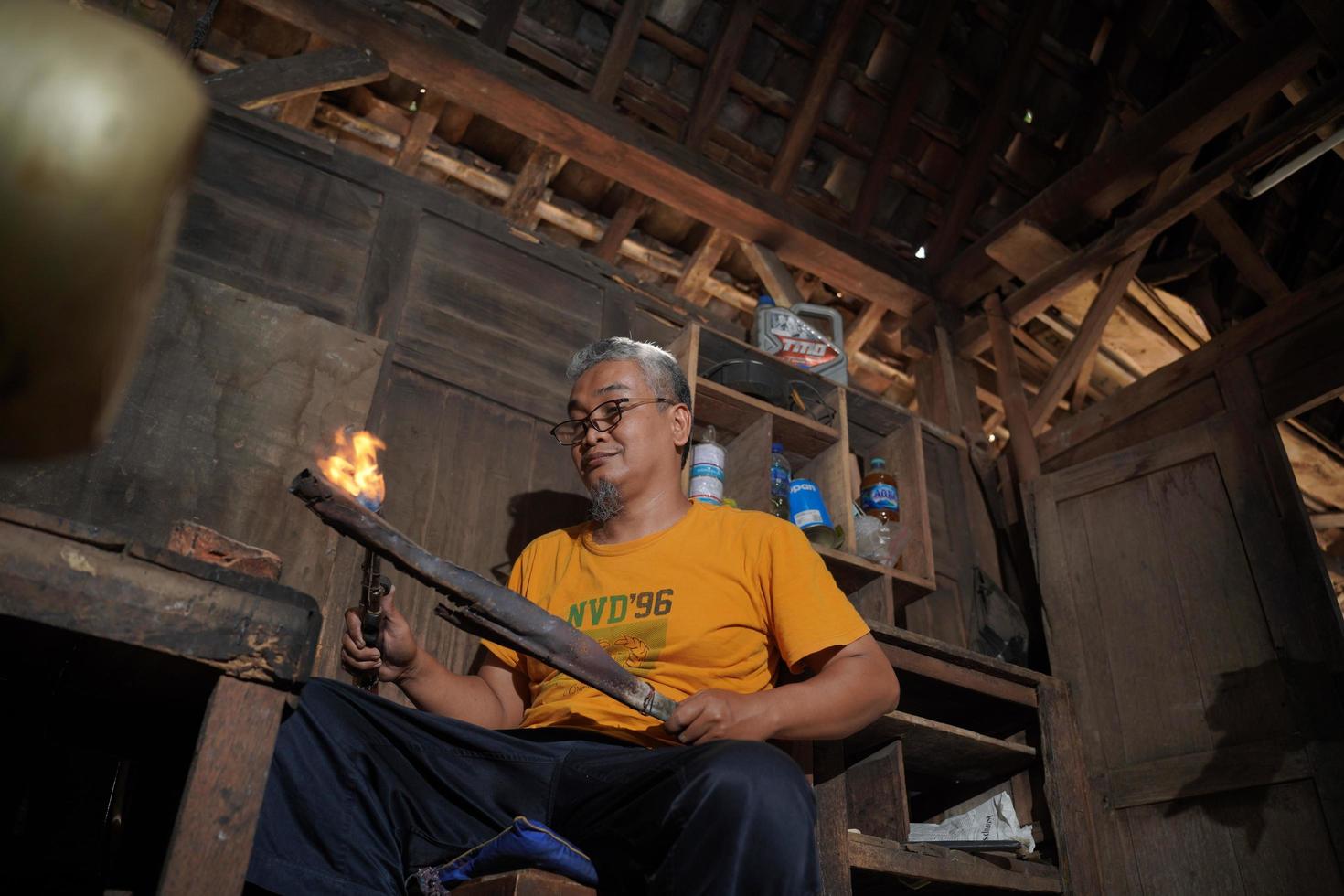 Craftsmen are making keris in the workshop. Javanese traditional weapon. Bantul, Indonesia - 25 August 2022 photo