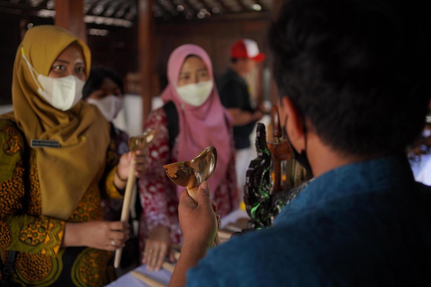 Visitors looking at a collection of kerises in a gallery. Bantul, Indonesia - 25 August 2022 photo