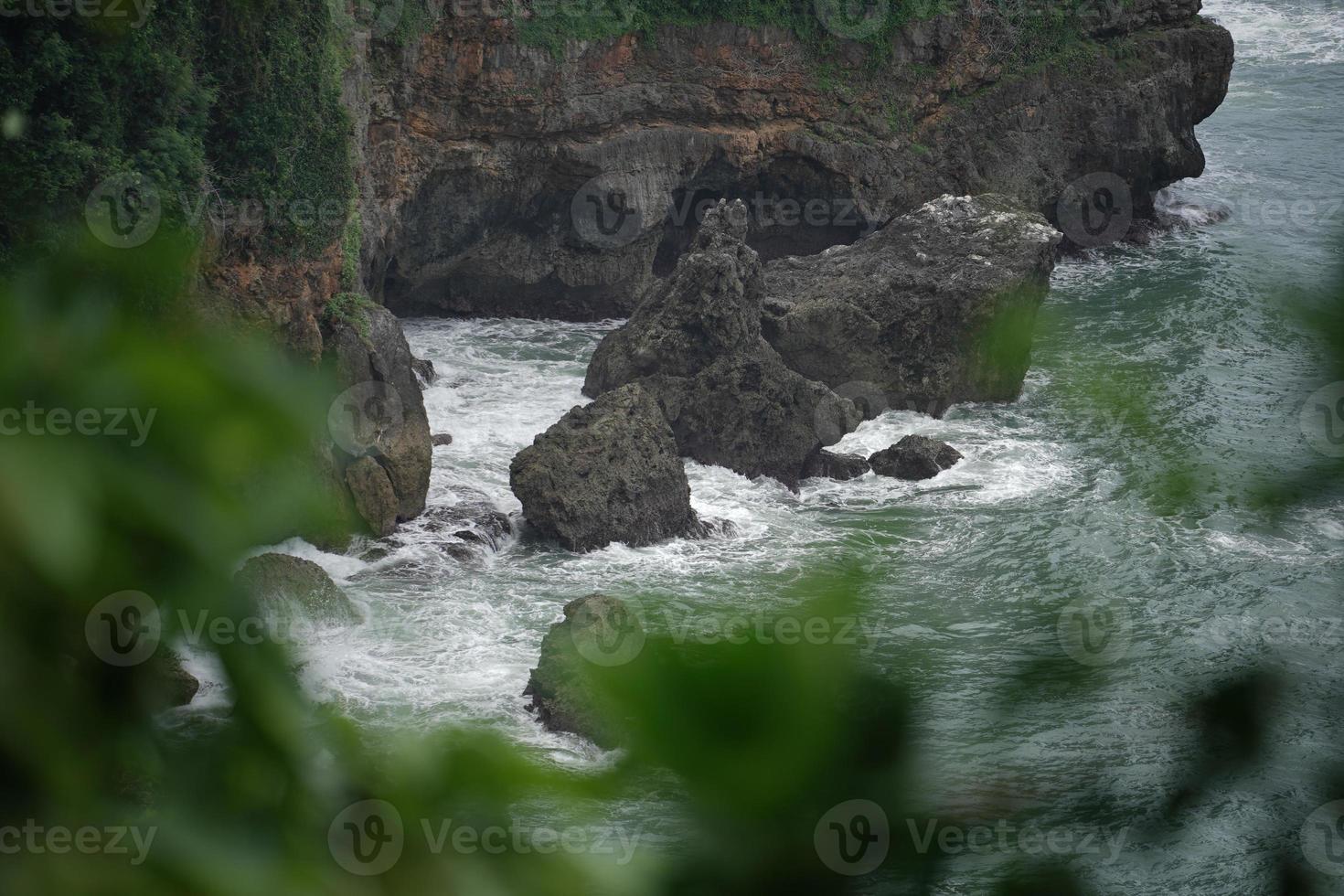 landscape views of cliffs and waves crashing into the reef. Very dangerous place. photo