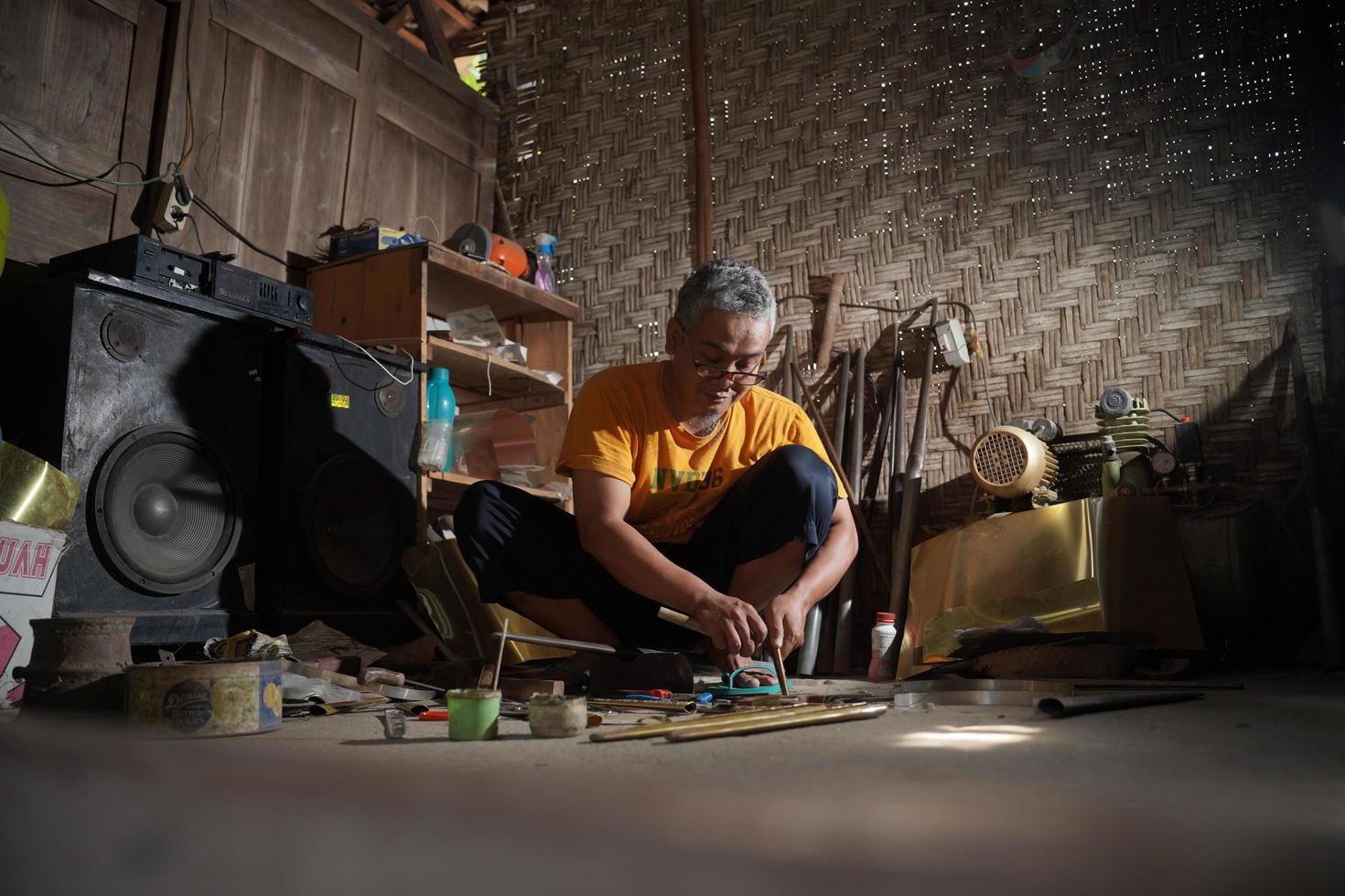 Craftsmen are making keris in the workshop. Javanese traditional weapon. Bantul, Indonesia - 25 August 2022 photo