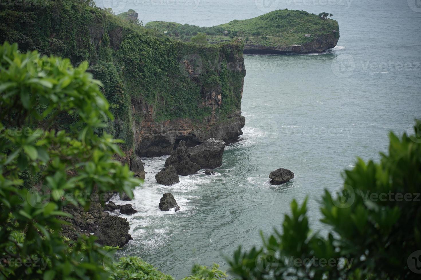 landscape views of cliffs and waves crashing into the reef. Very dangerous place. photo