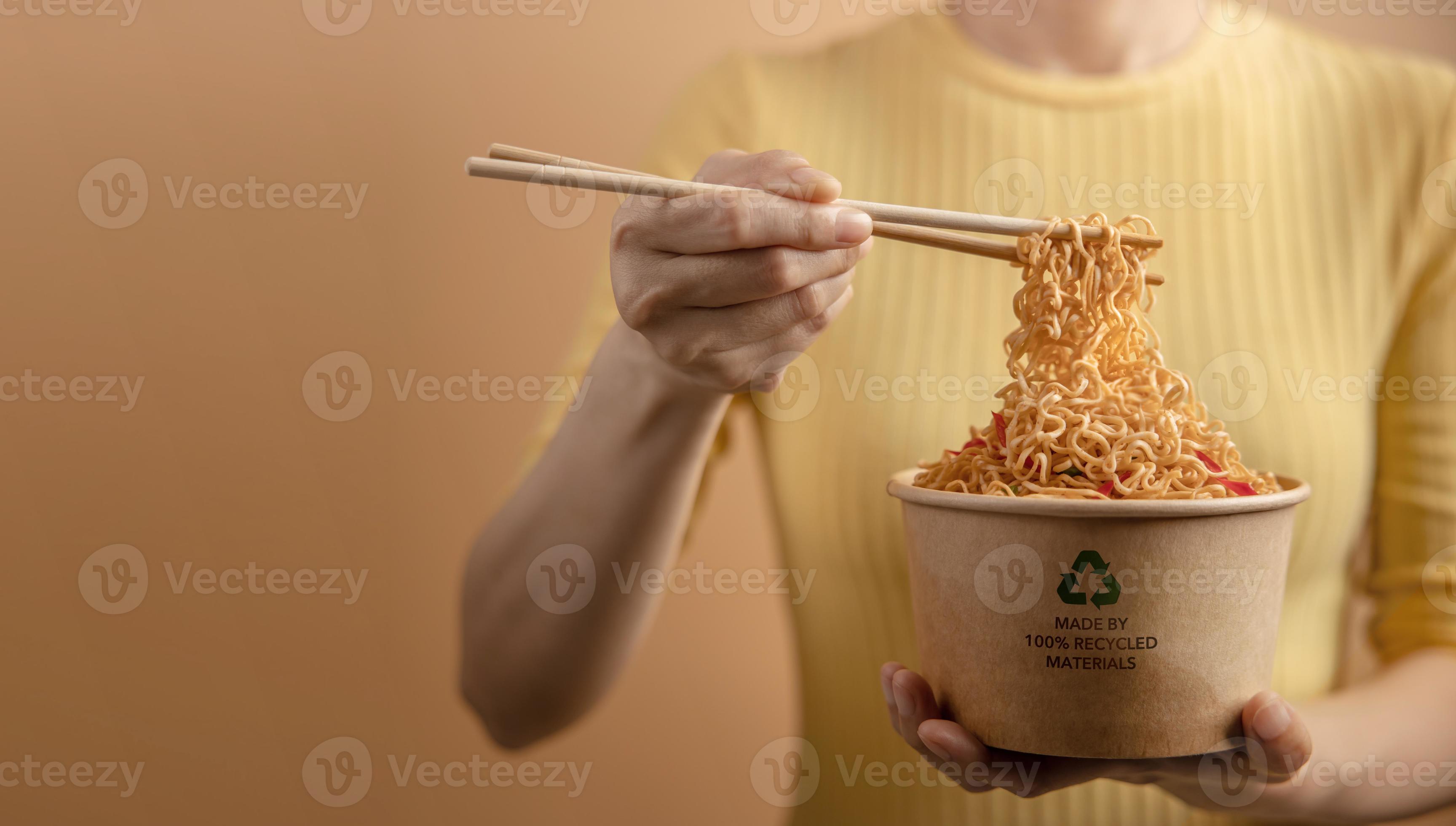 Recycled Packaging Concept. Woman Using Chopsticks to Eating Hot Boiled