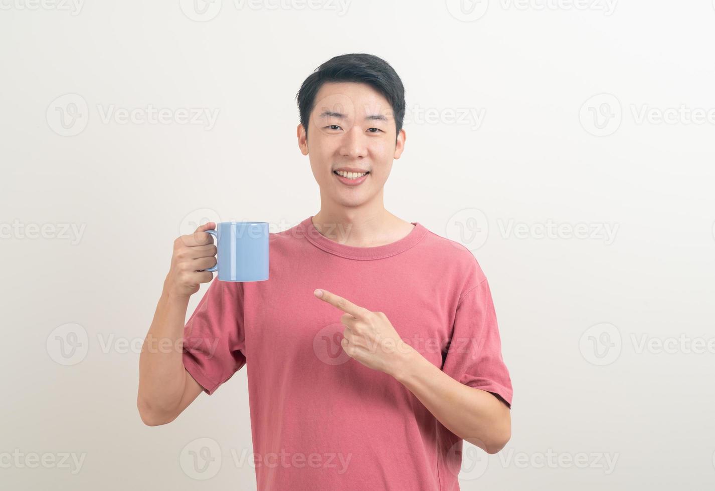 young Asian man holding coffee cup photo