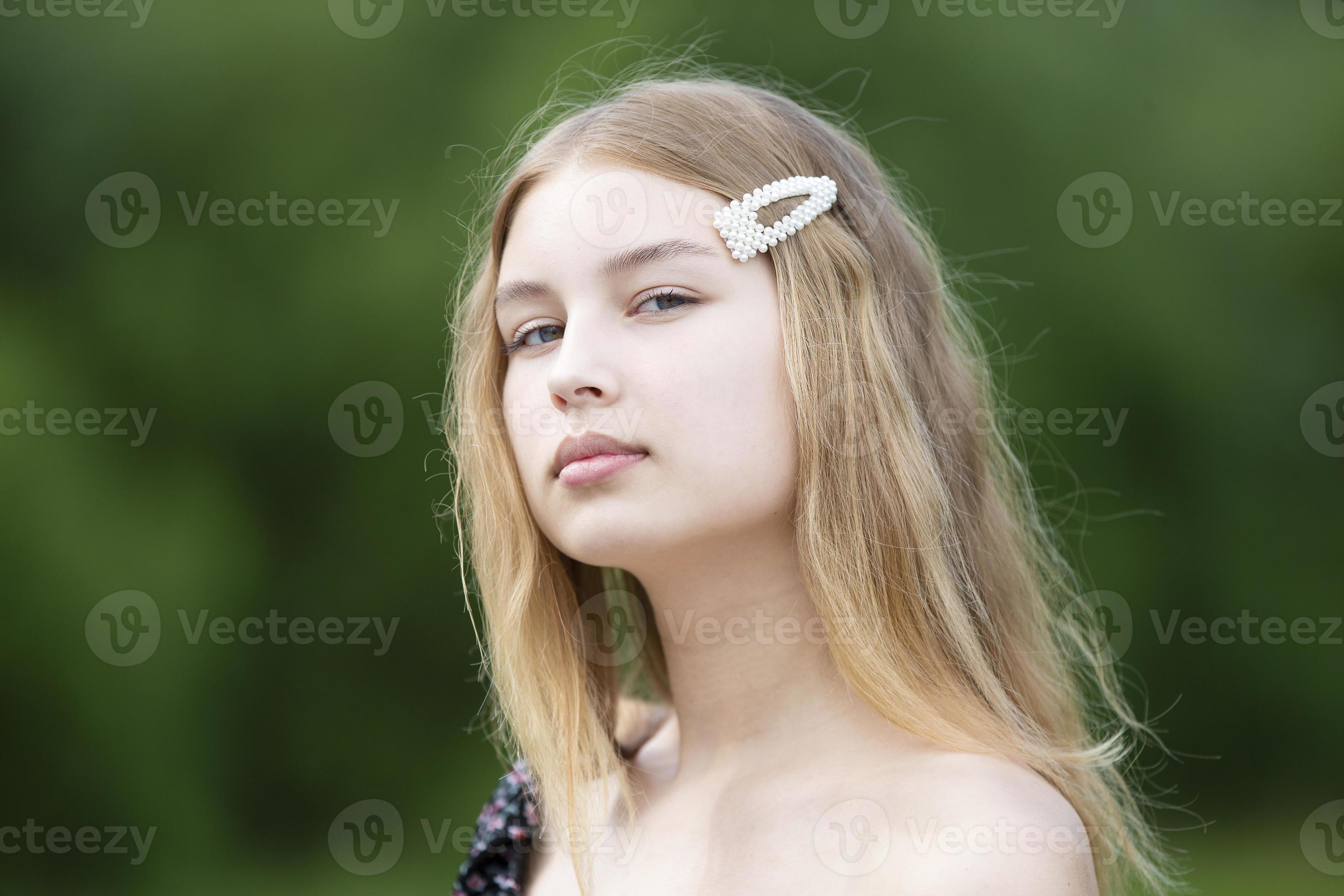 Portrait Of A Beautiful Girl With Long Hair On A Summer Background The