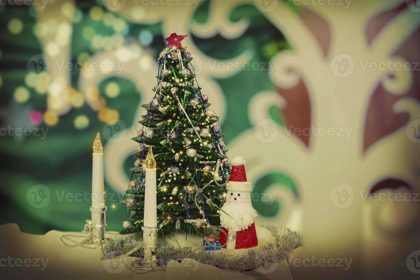 Vintage christmas background with fir tree candles and toy santa claus. photo