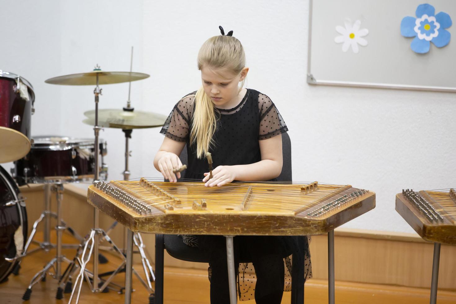 May 21, 2021 Belarus. city of Gomil. Holiday at the music school.The girl plays the ethnic instrument dulcimer photo