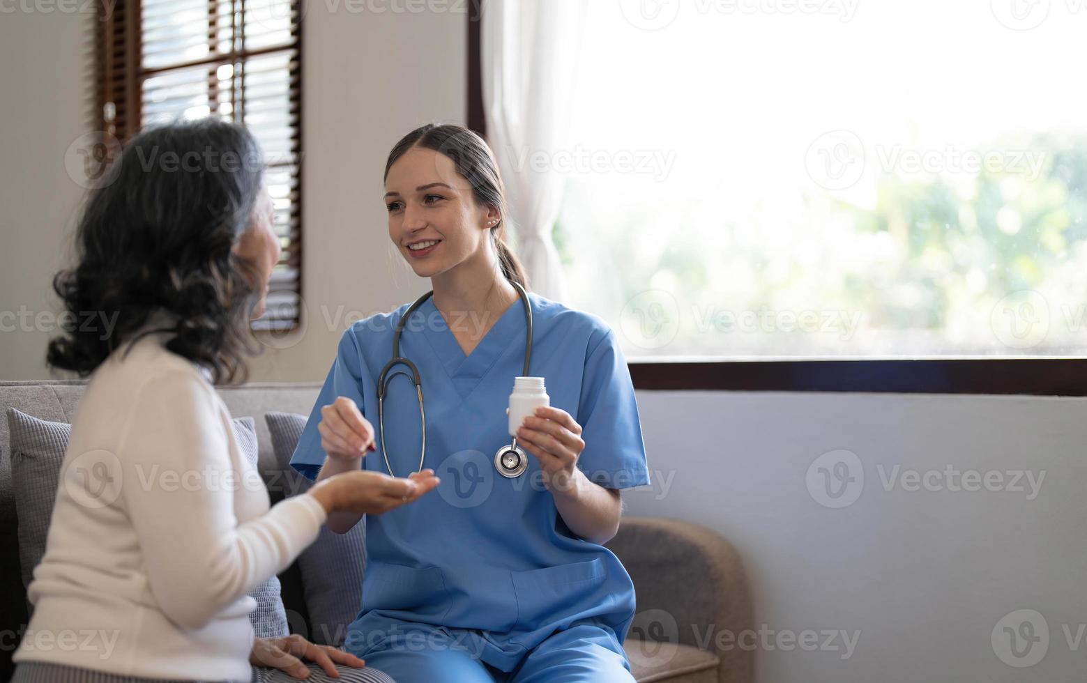 Asian nurse showing health checkup report to grandmather and giving advice. medical assisted living visit senior patient at home. Home nursing and healthcare caregiver concept photo