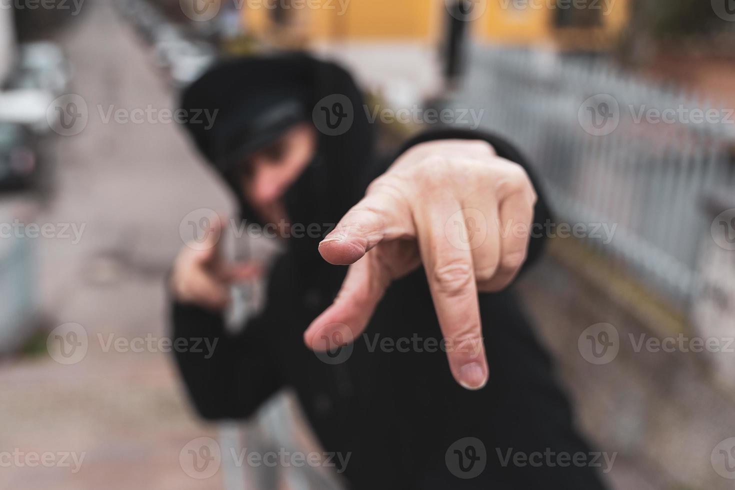 mature man rap singer posing in the street on the outskirts of a city photo