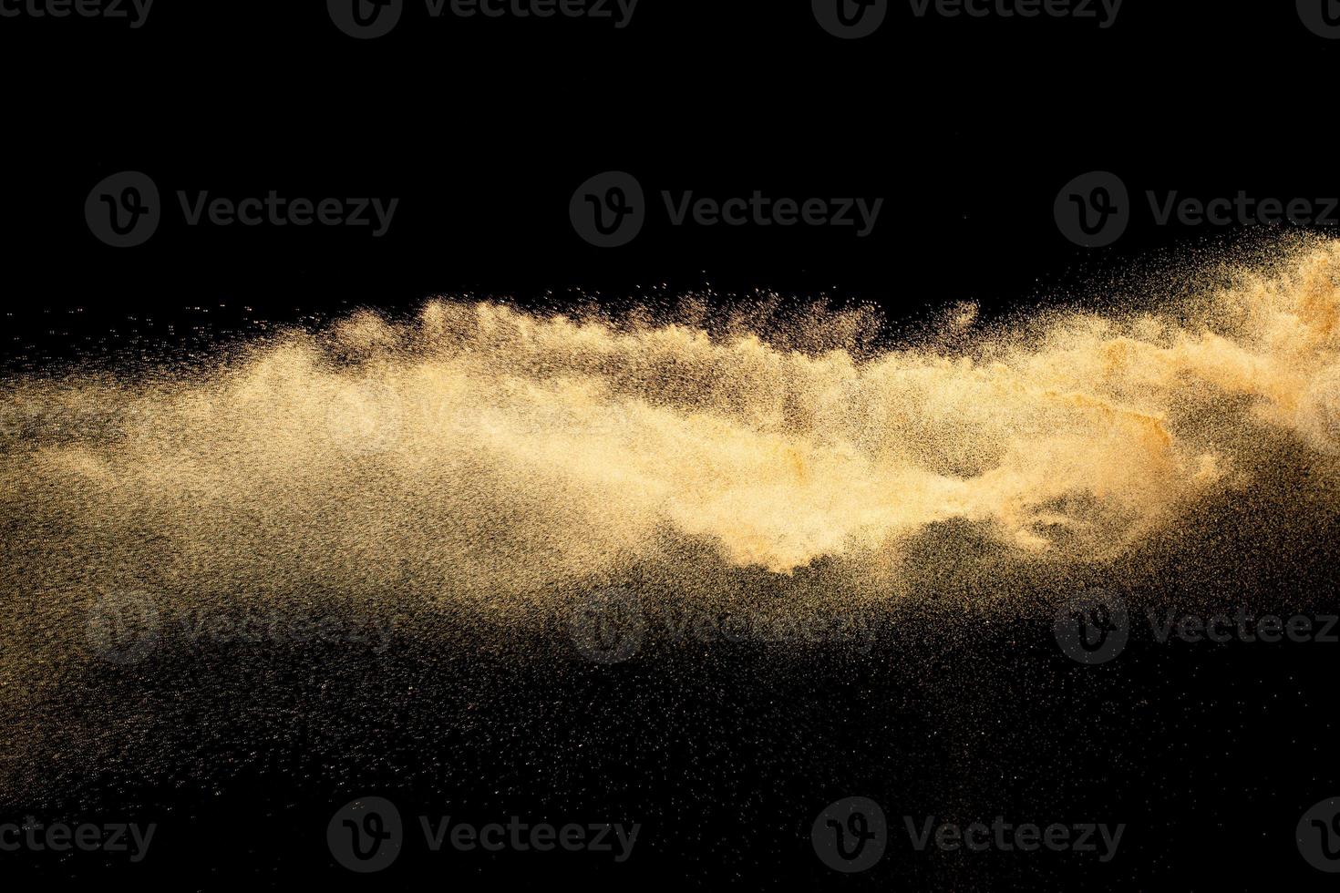 Brown colored sand splash.Dry river sand explosion isolated on black background. photo