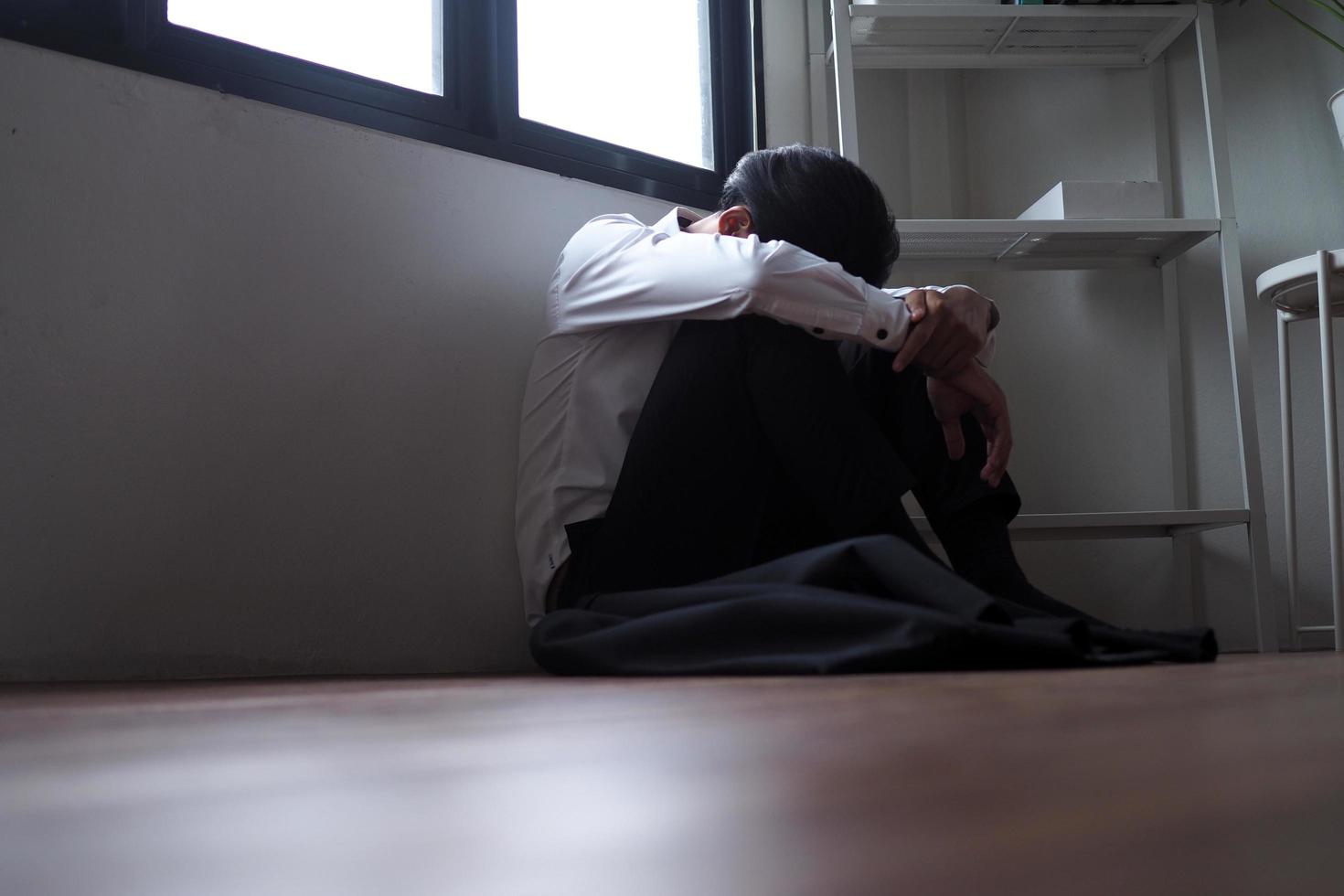 Businessmen sitting inside the office alone are stressed. photo