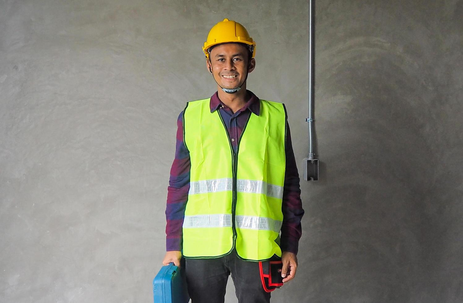 Asian engineer or chief contractor with hard hats and coats photo
