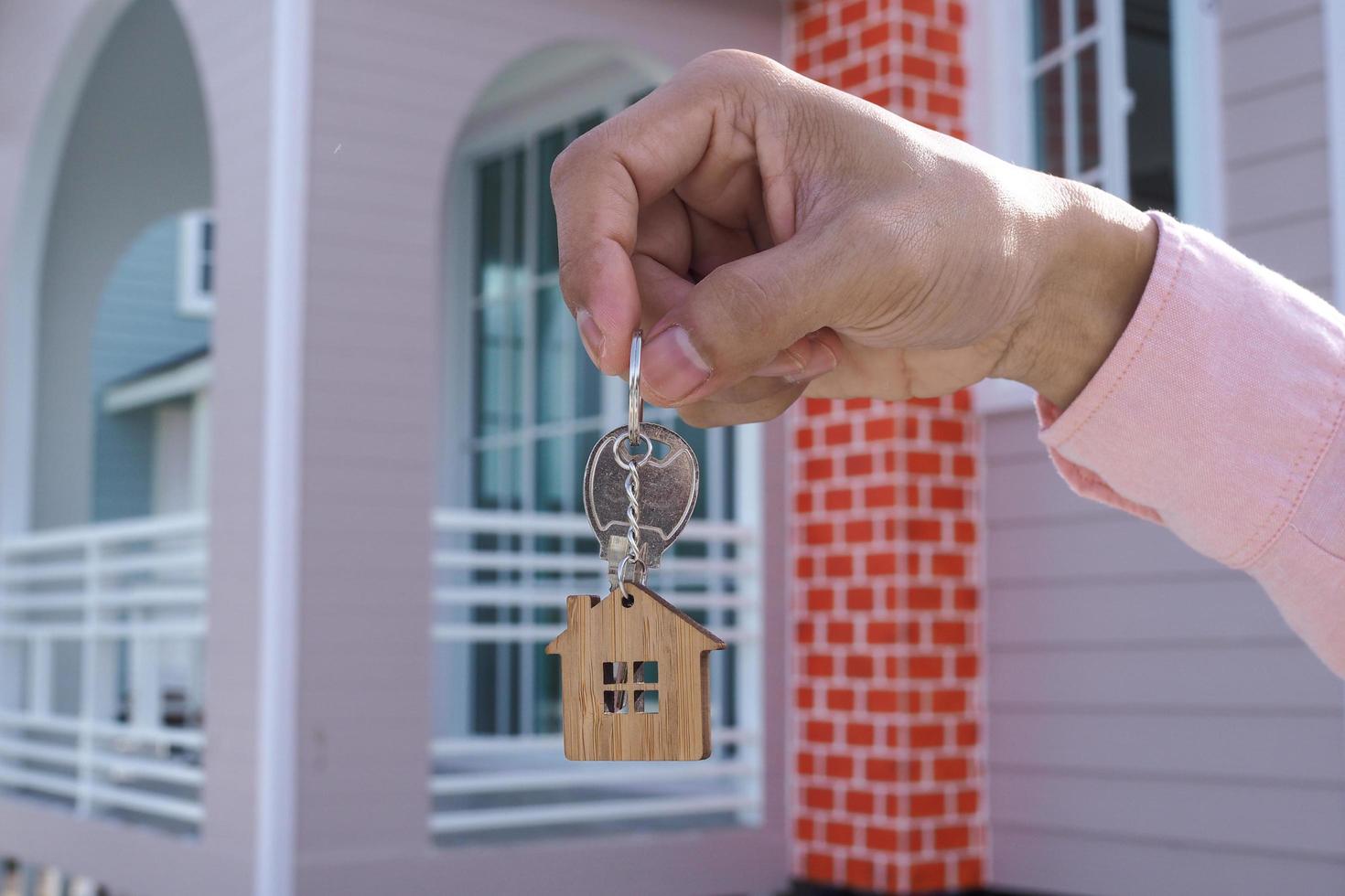 Landlord unlocks the house key for new home photo