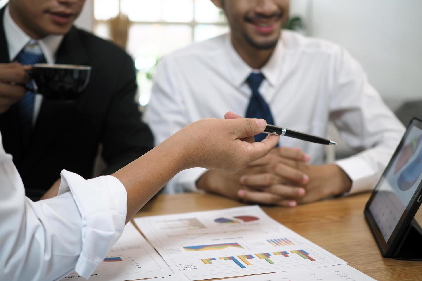 Businessmen together brainstorm ideas for calculating statistical data of investment budgets, making new projects. photo