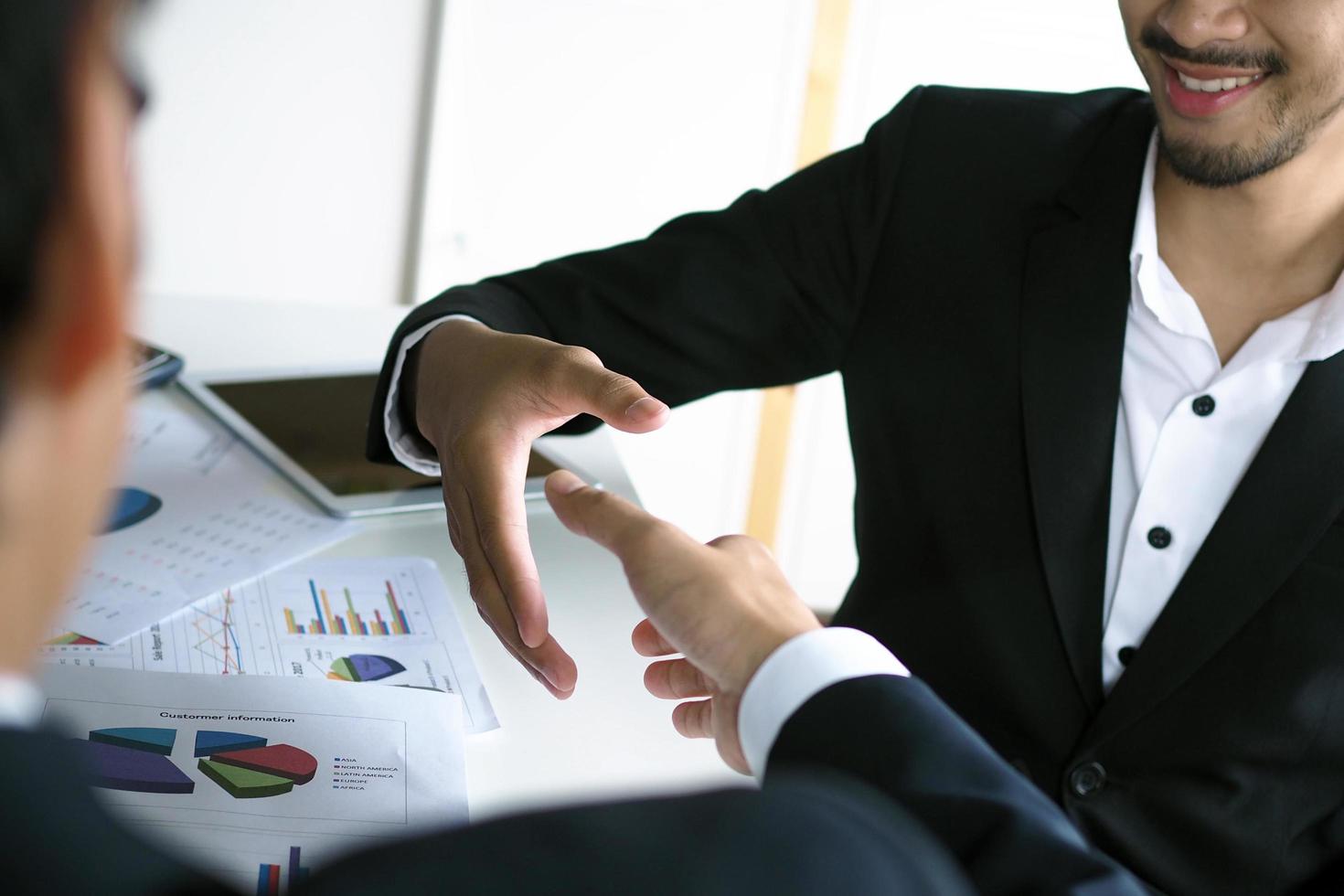 Two businessmen shake hand to show satisfaction in business negotiations. Happiness in working as a partner photo